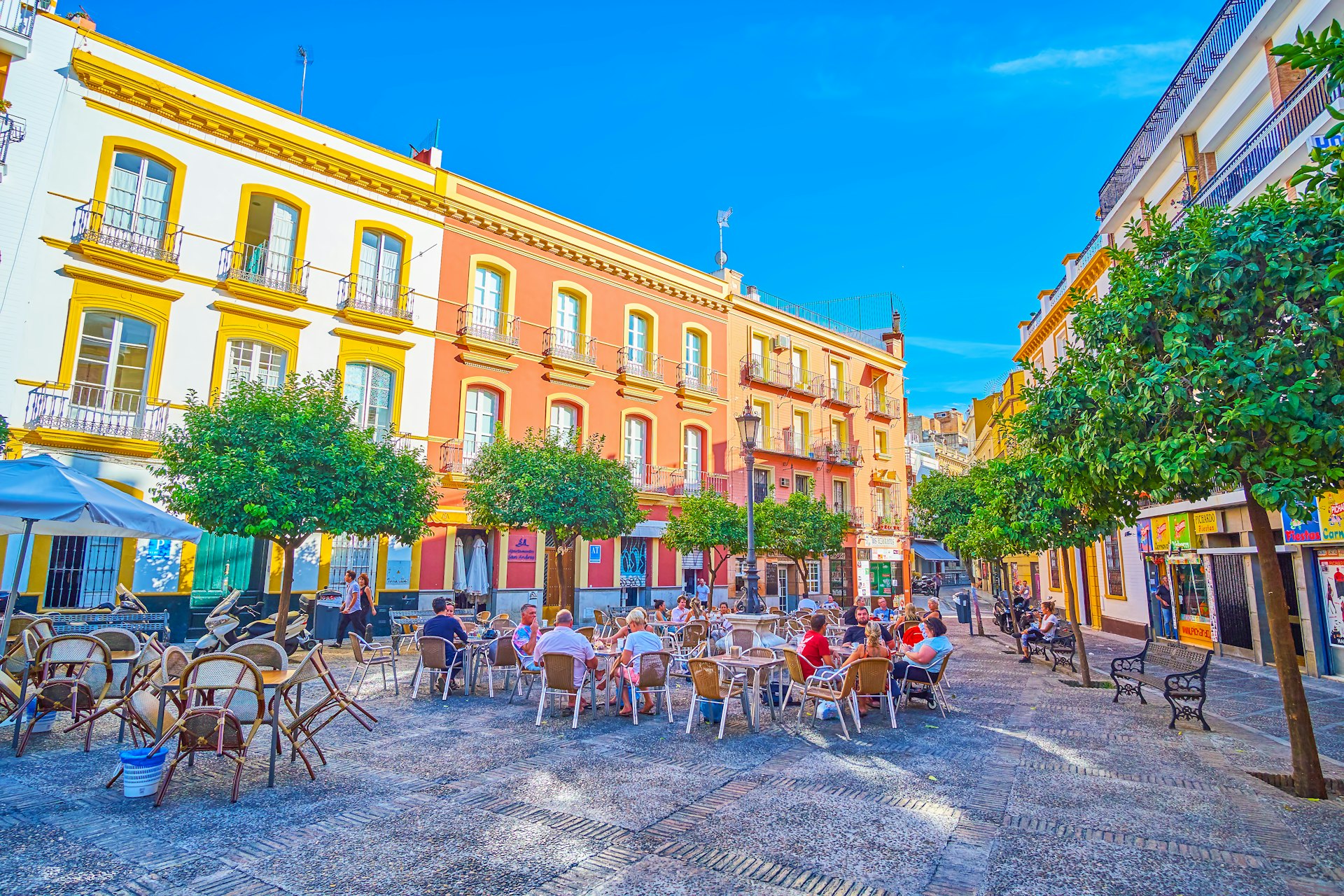 The small triangle Plaza de San Andres with outdoor cafe tables in Seville 