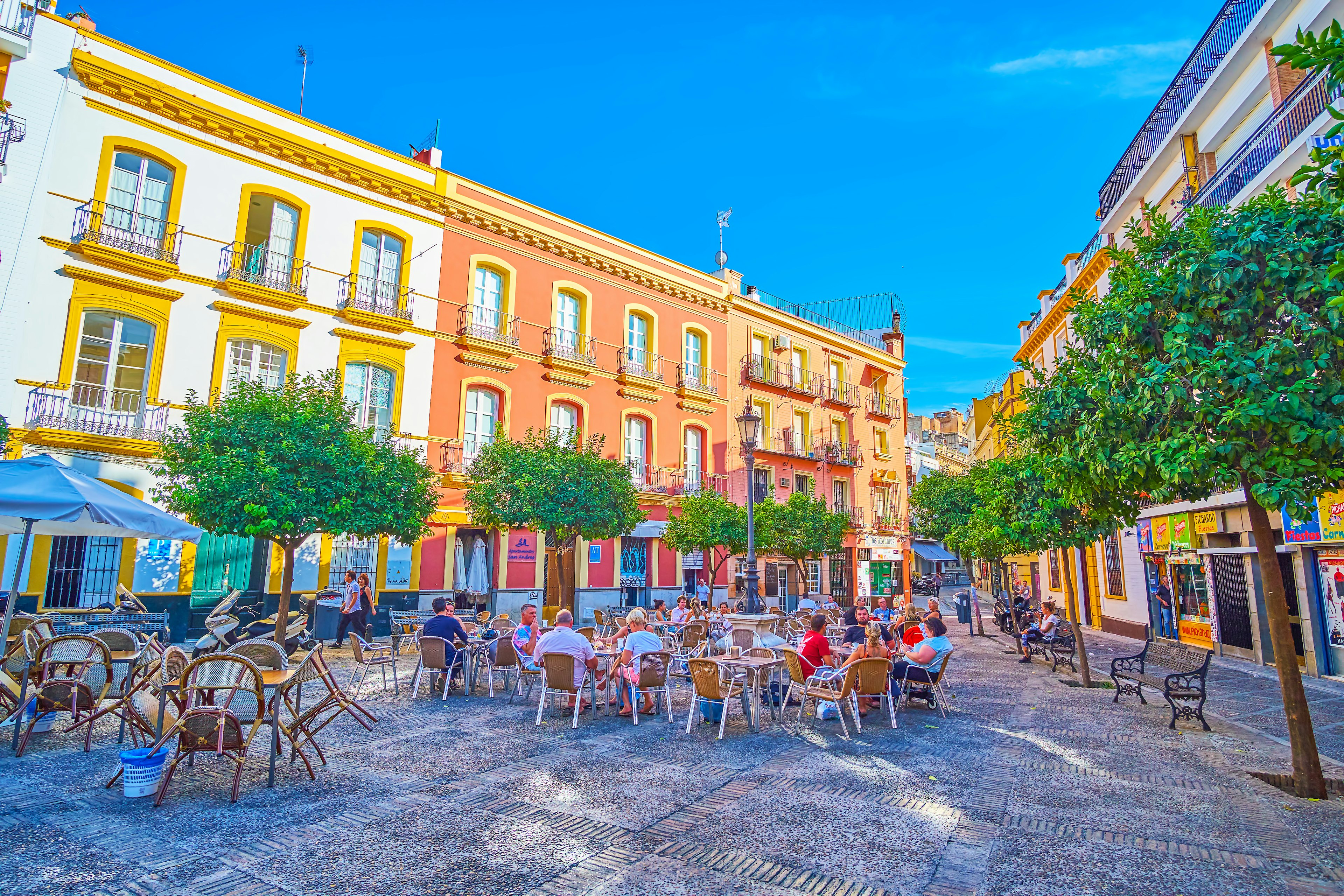 The small triangle Plaza de San Andres with outdoor cafe tables in Seville