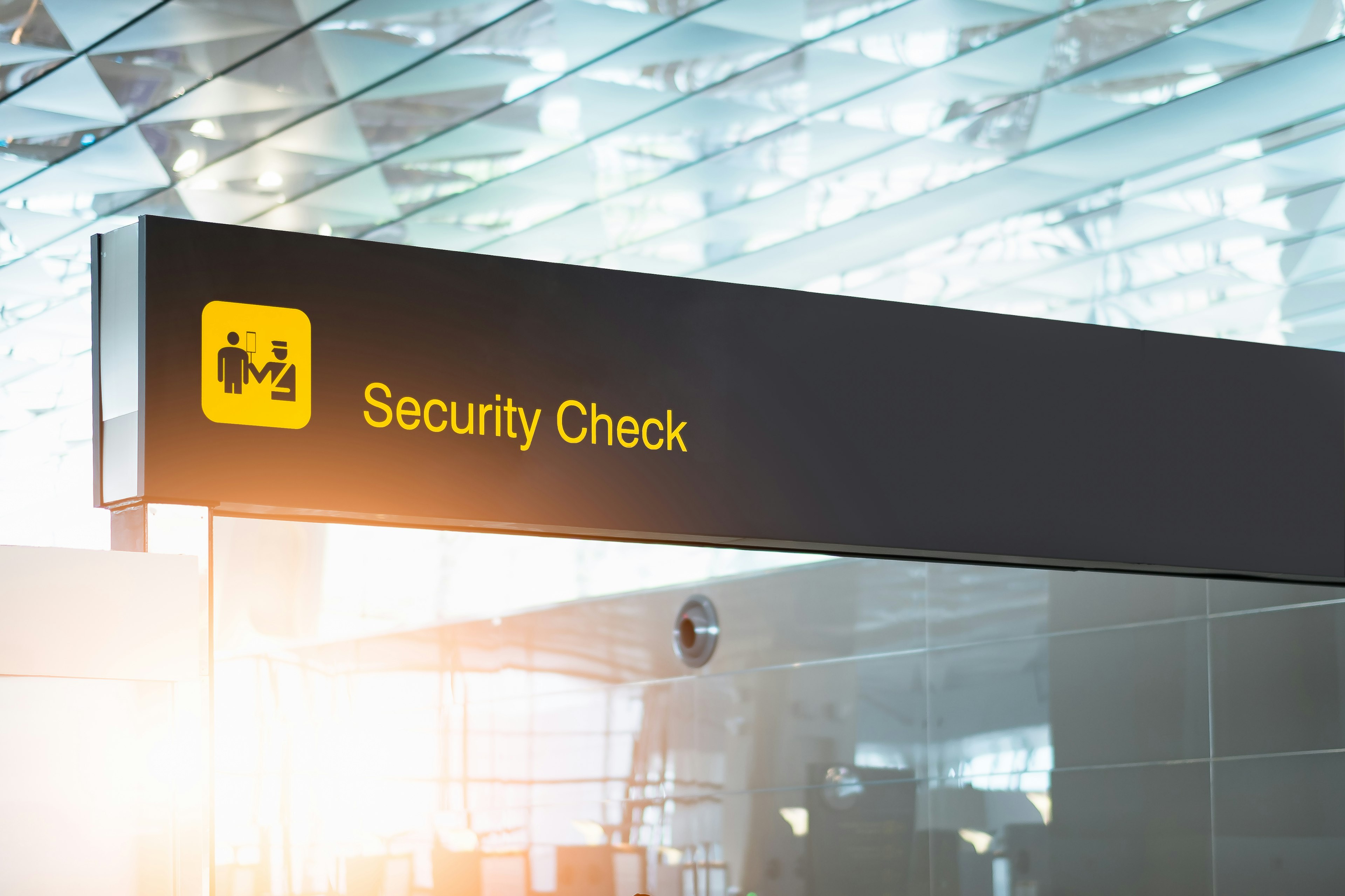 A sign indicating that airport security is ahead for people at an airport