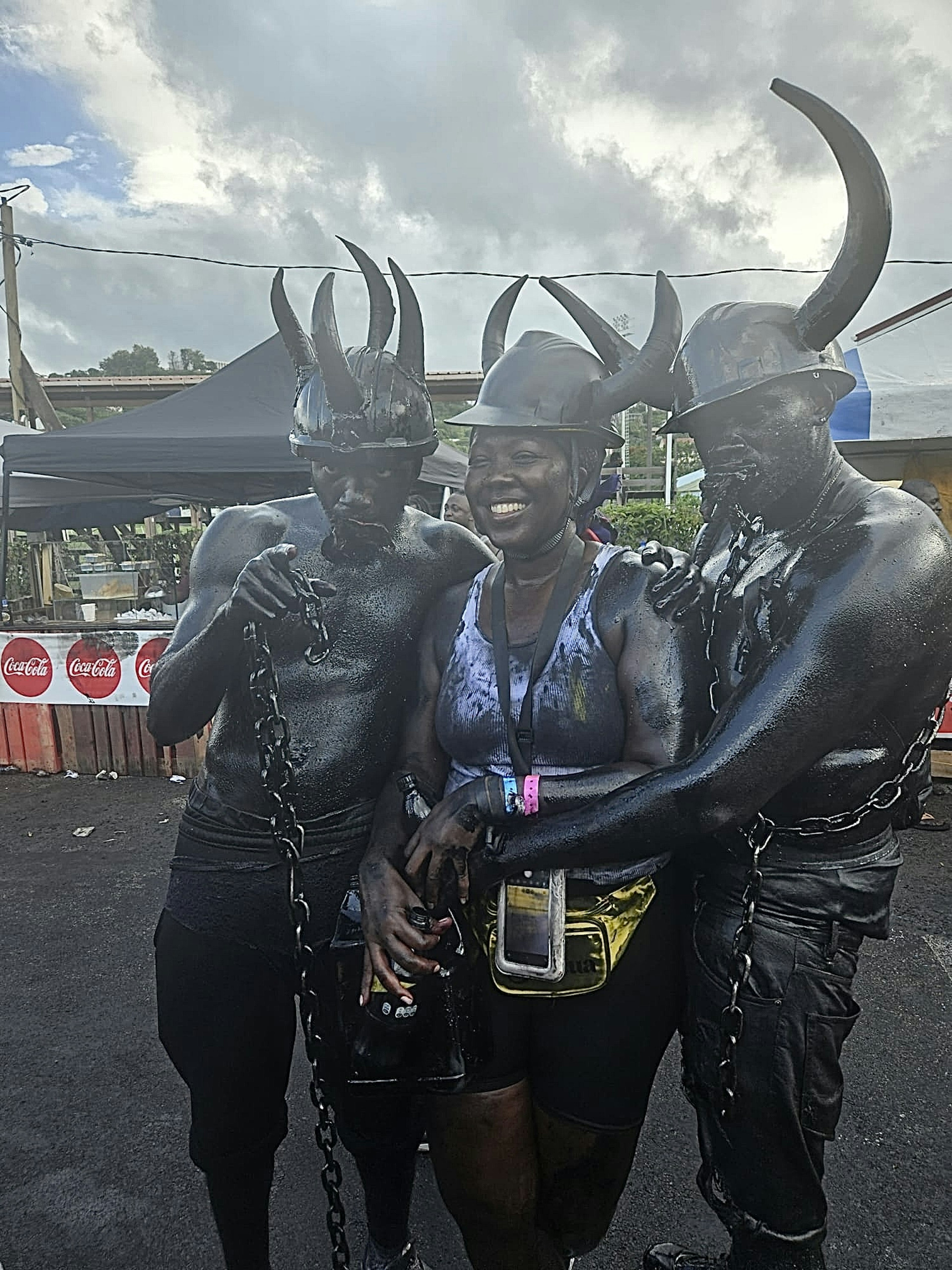 Lonely Planet destination editor Alicia Johnson poses with a pair of Jab Jab characters during J'Ouvert in Grenada for Spicemas.