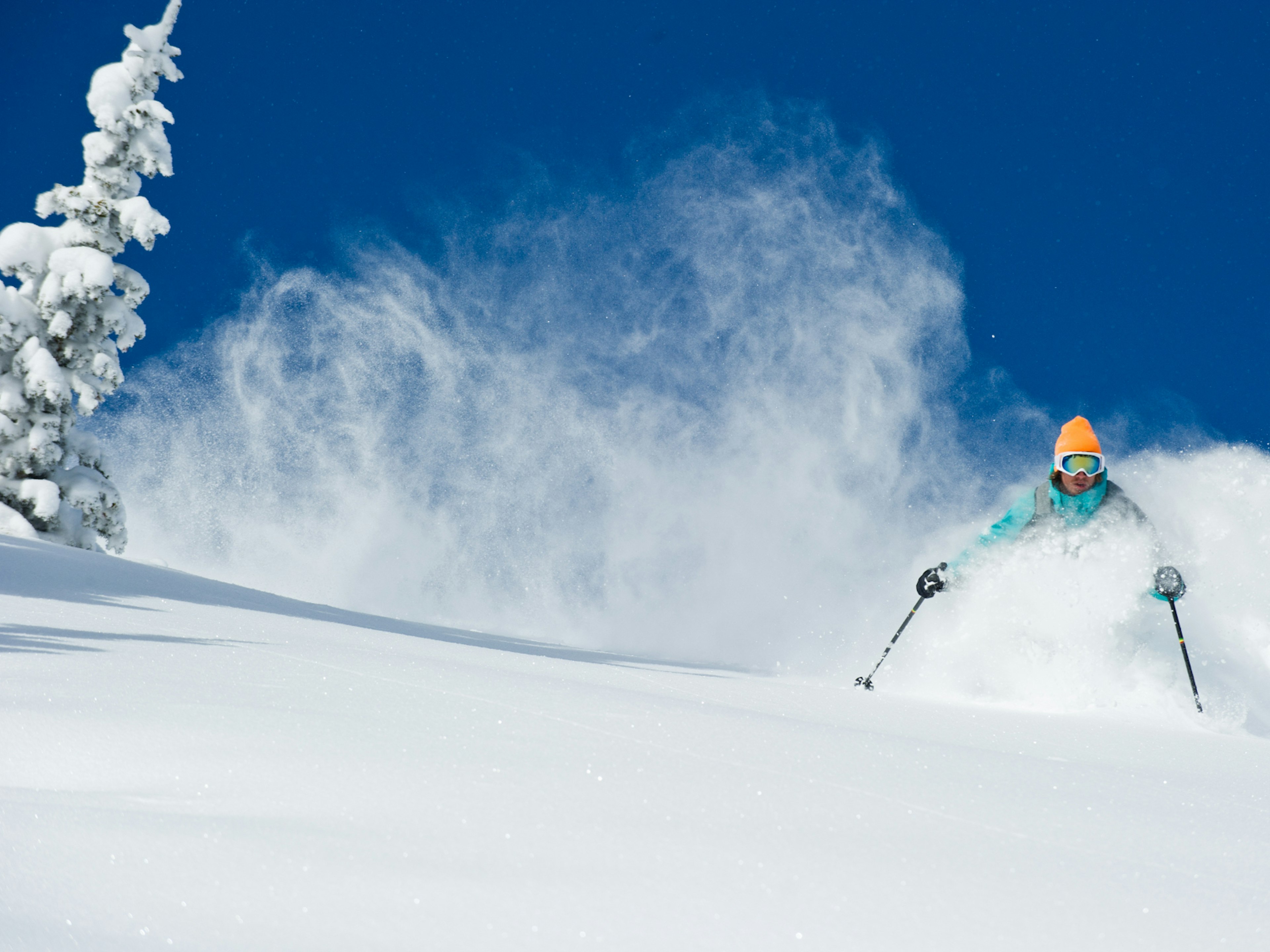 Skier going through powdery snow in Alta, Utah