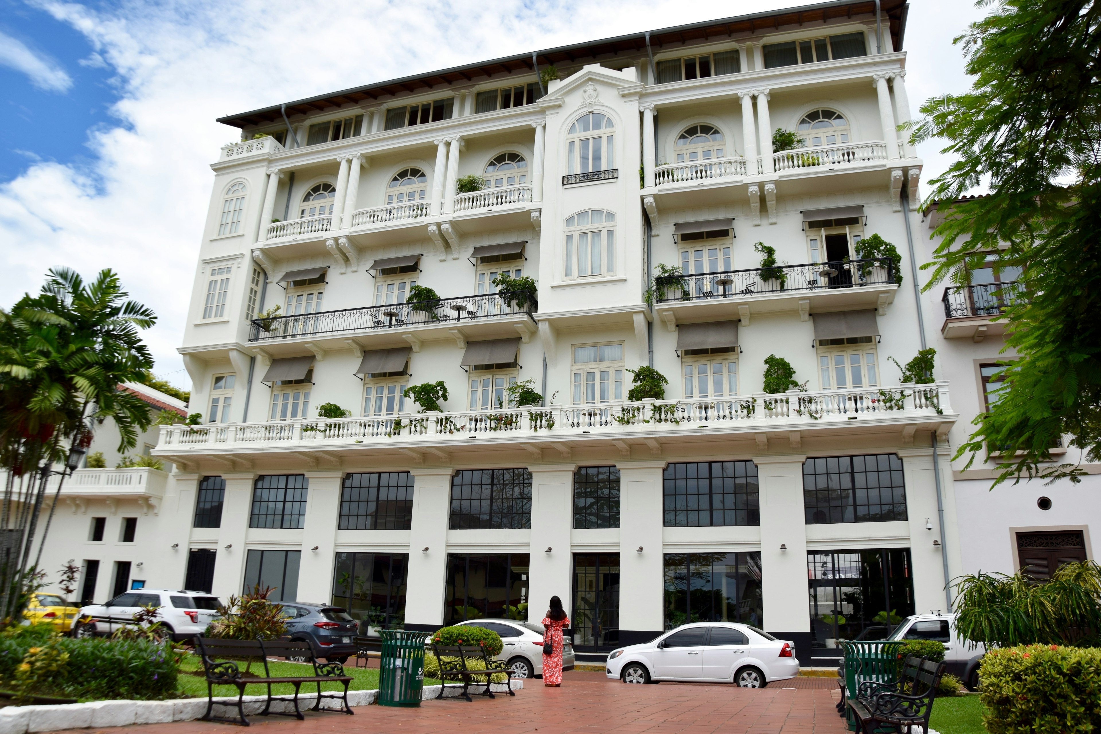 A woman stands in front of the American Trade Hotel in Panama; perfect weekend Panama