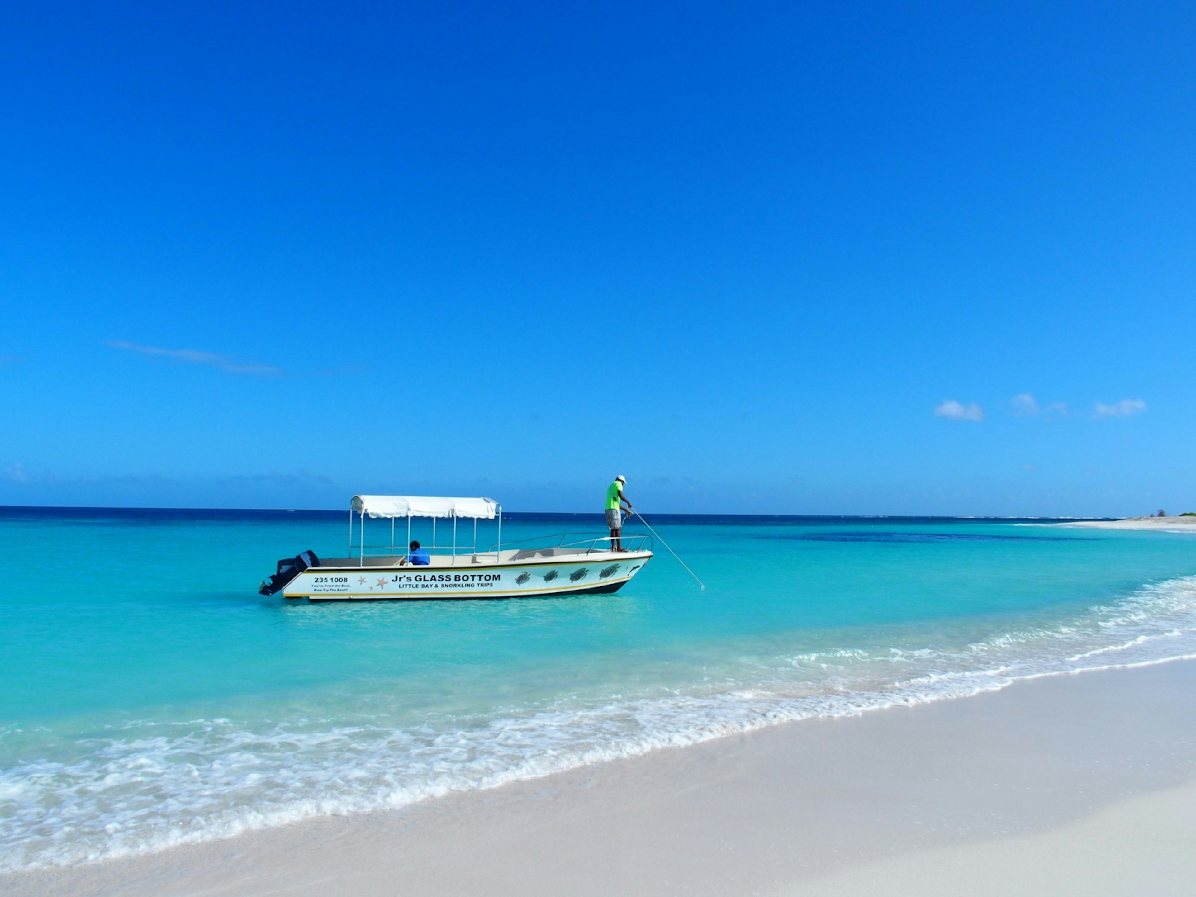 A glass-bottom boat makes its way to shore at Shoal Bay Beach in Anguilla