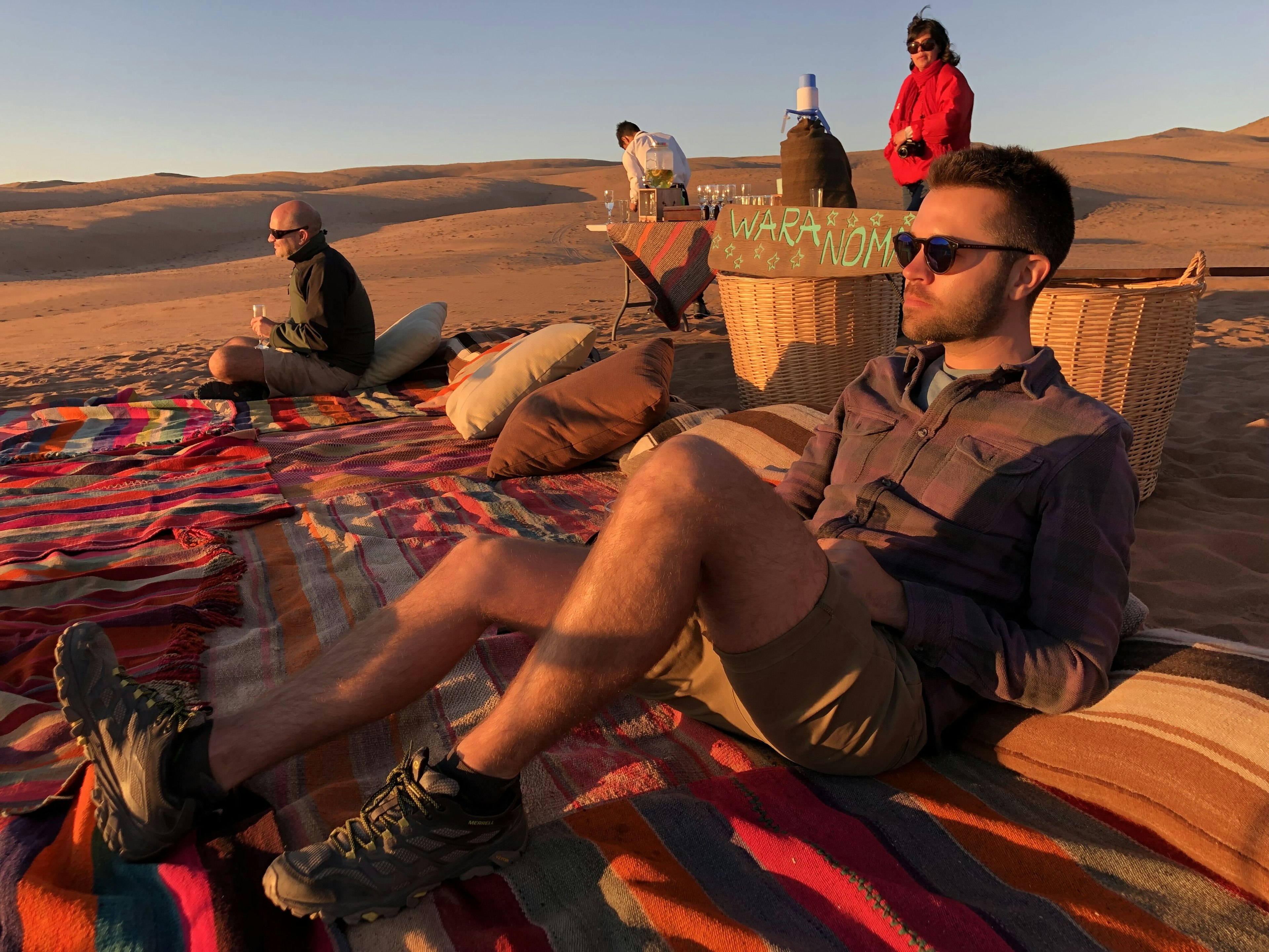 A man looks into a sunset in a desert scene