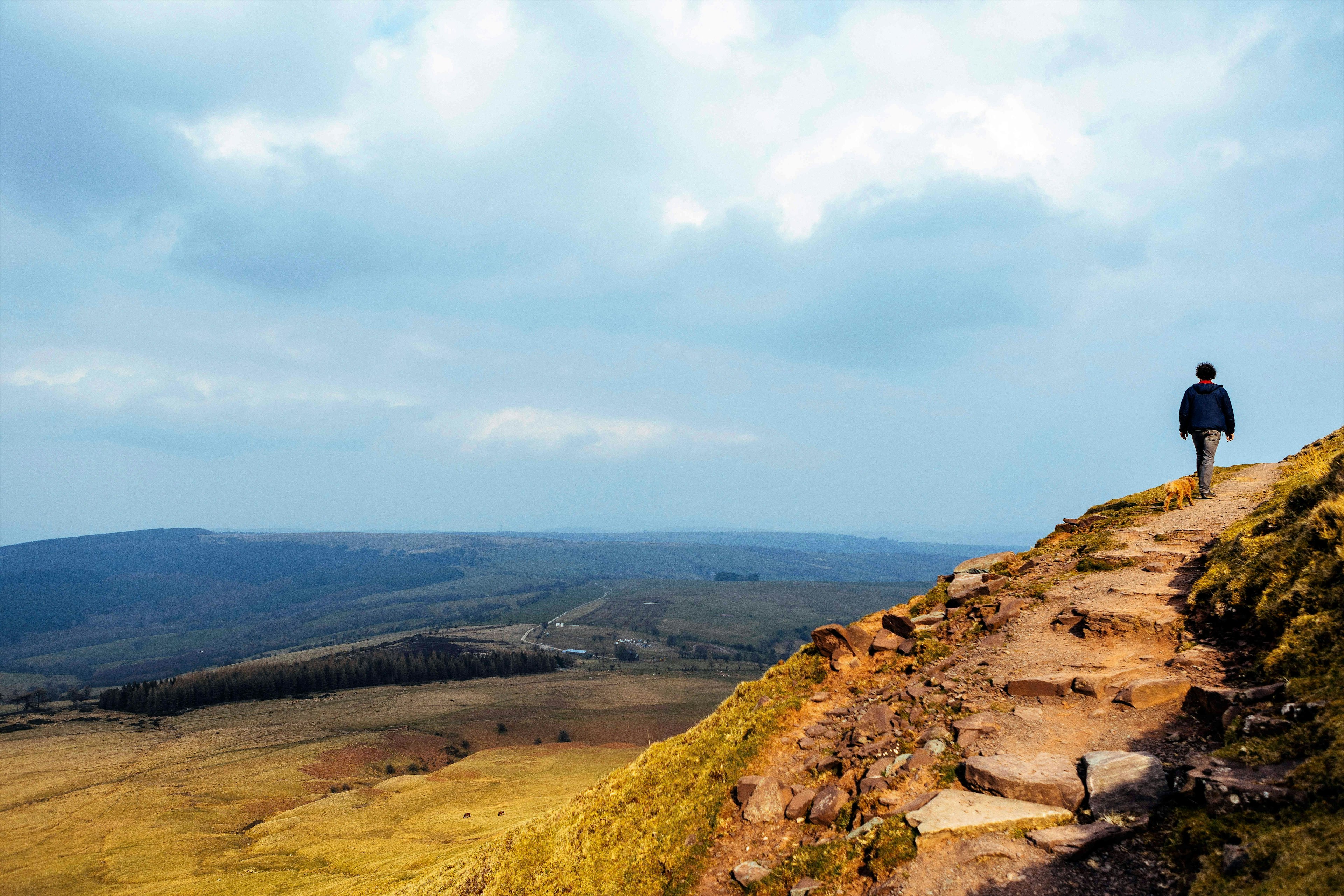 A figure walks along a ridge on the Offa's Dyke Path