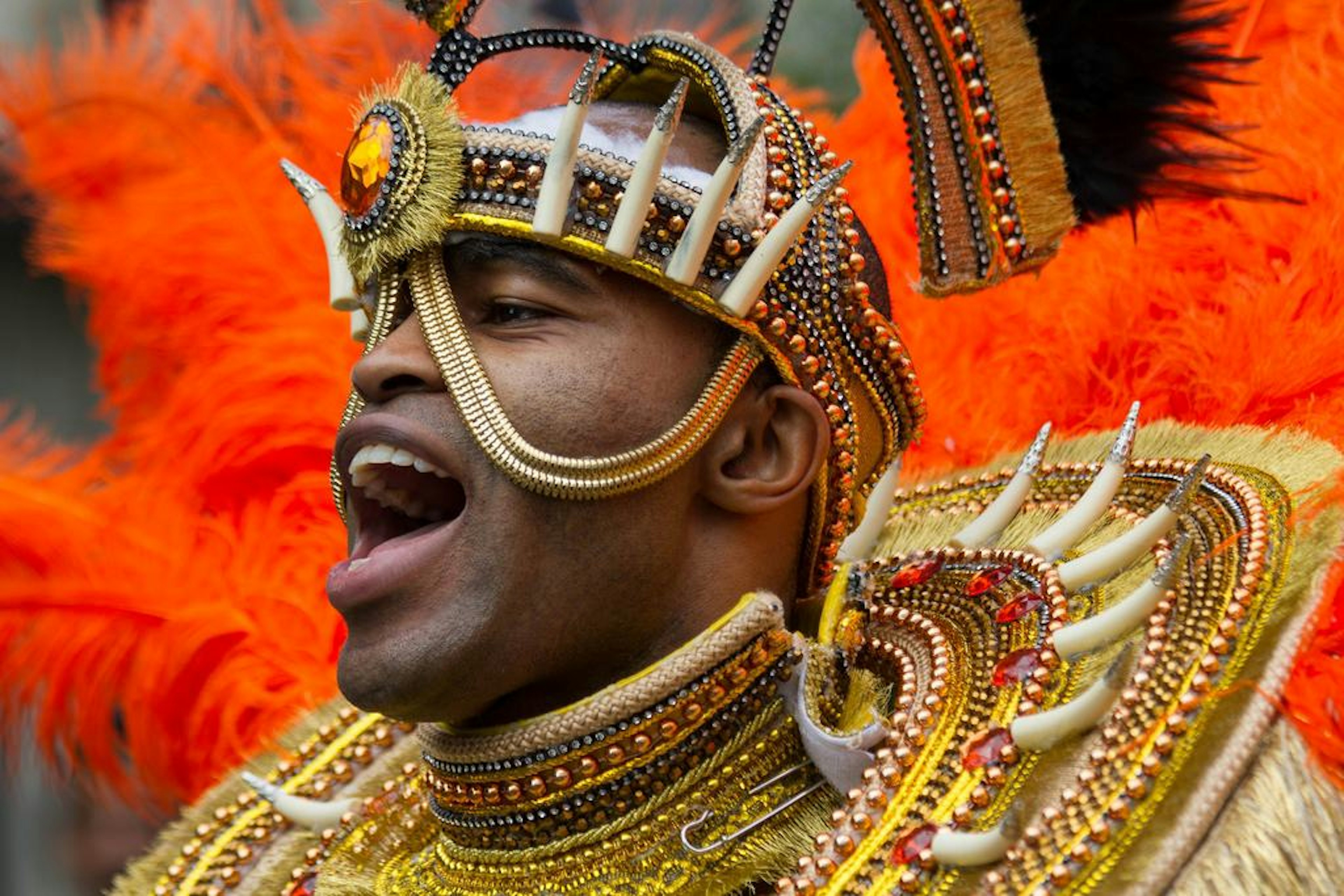 Man wearing a flamboyant costume at Notting Hill Carnival.