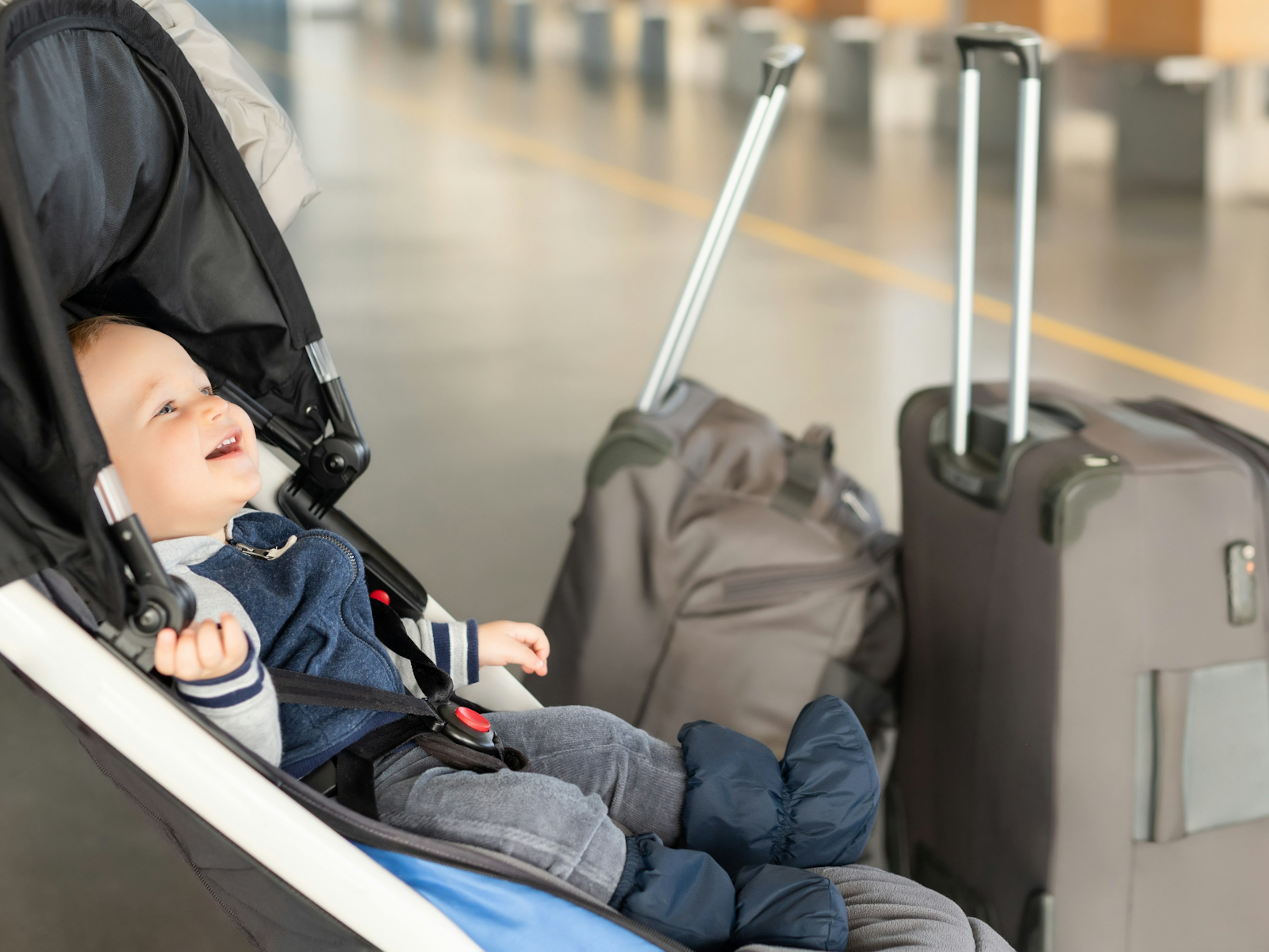 A baby in a stroller at the airport