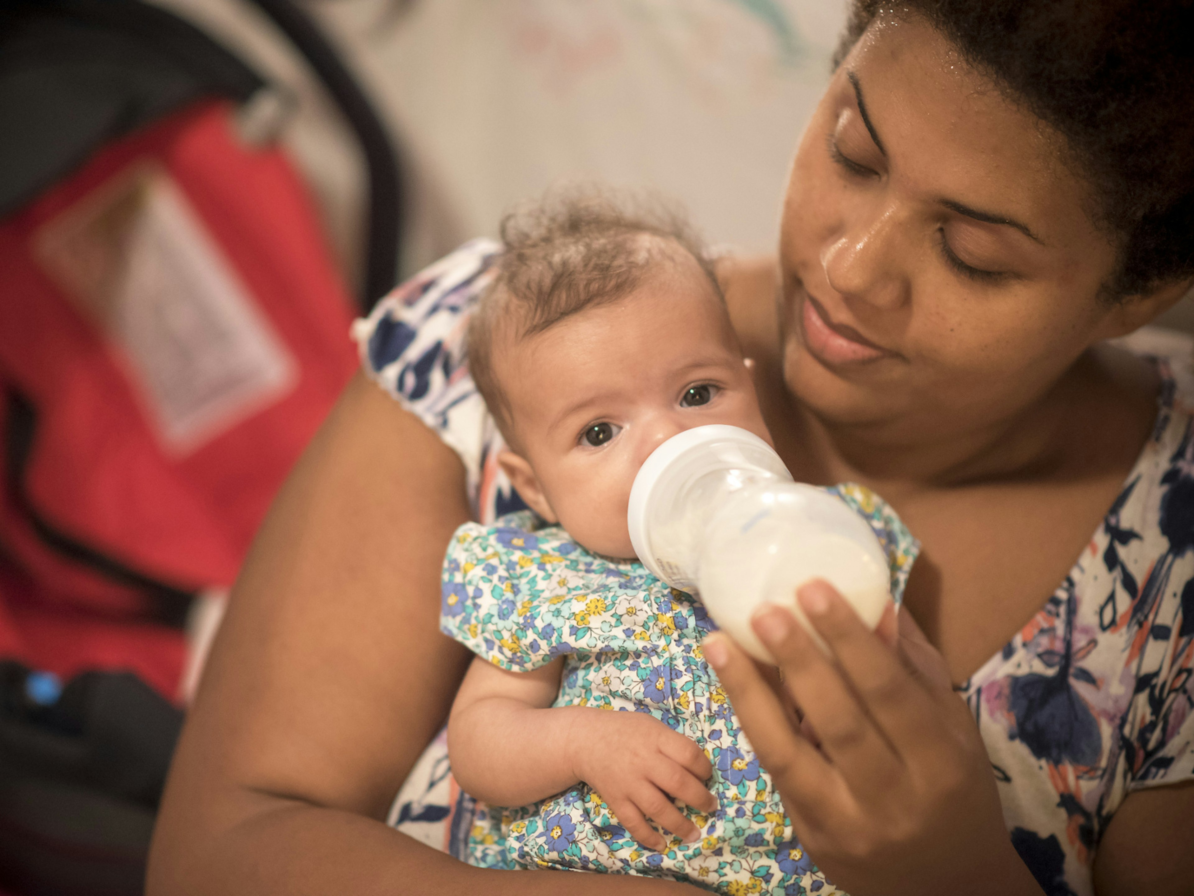 A mother bottle feeding her baby