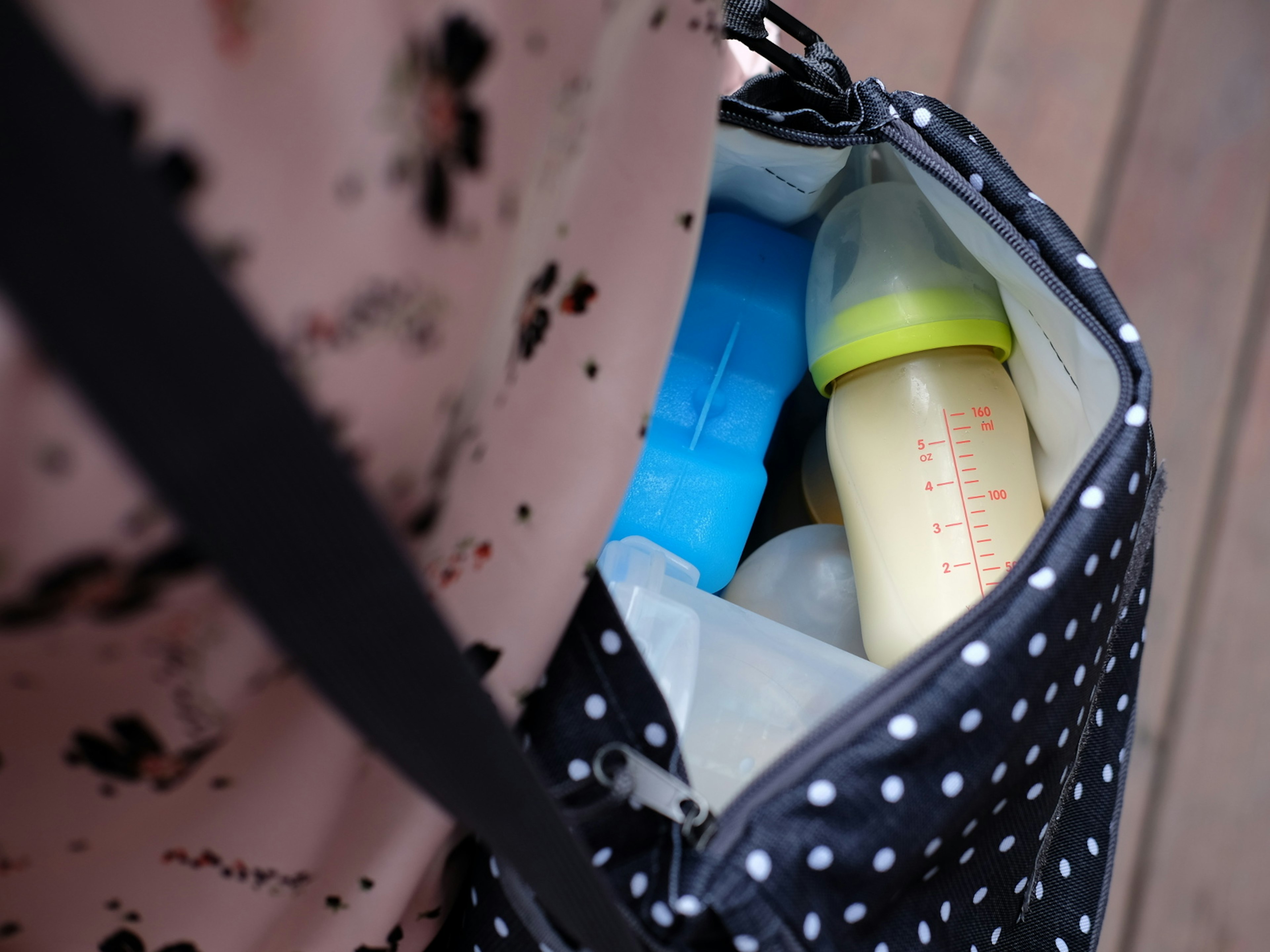 A baby bag with a bottle of formula