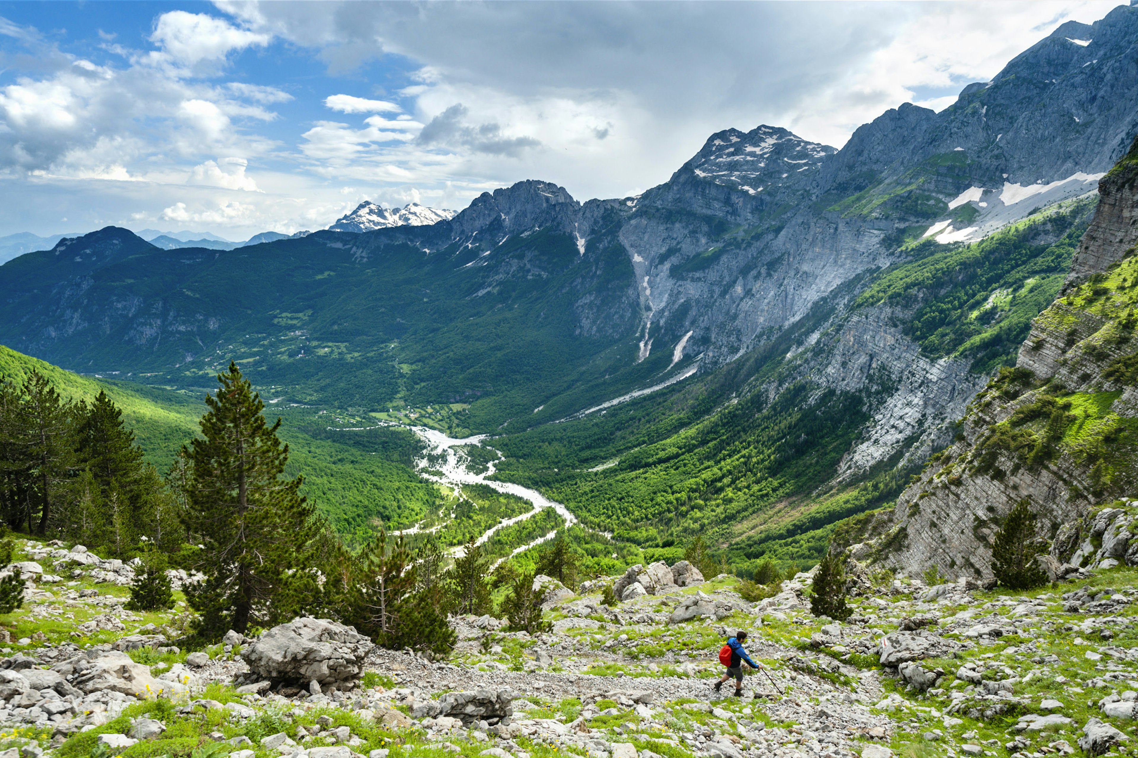 Snow-dappled peaks frame the forested valley above Theth