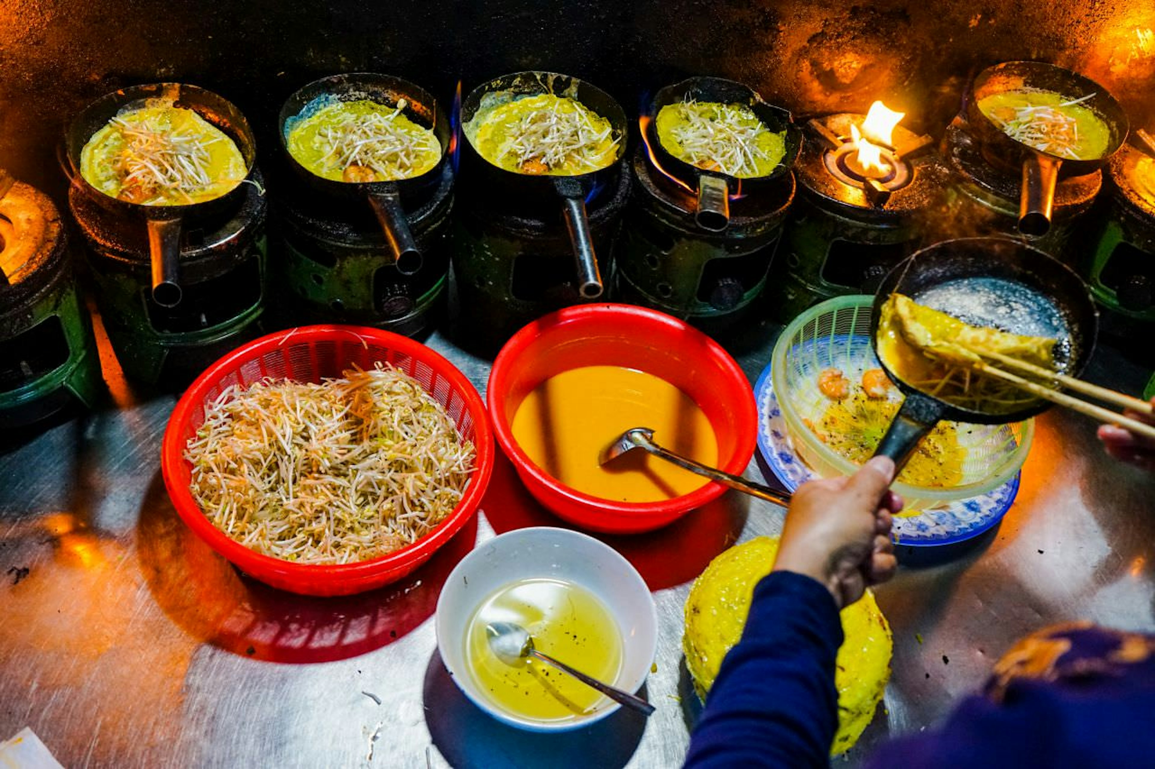 Sizzling pancakes, or banh xeo, are served with shrimp, pork and organic herbs