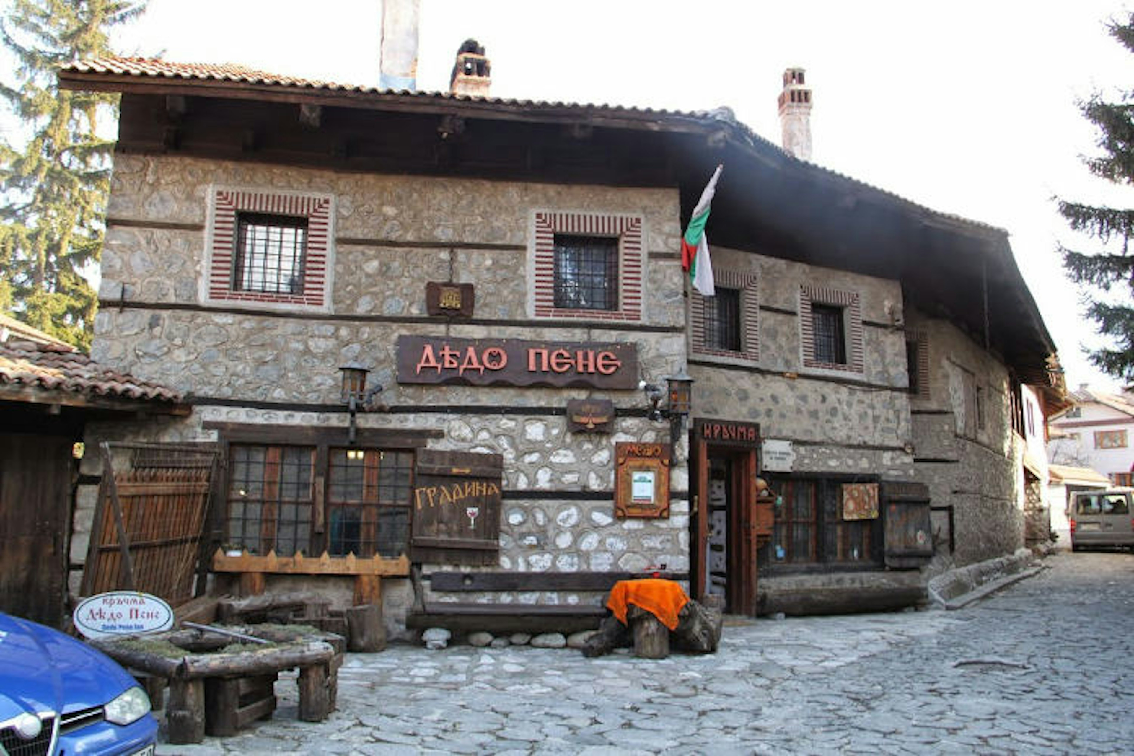 A two-storey stone building on a cobbled street