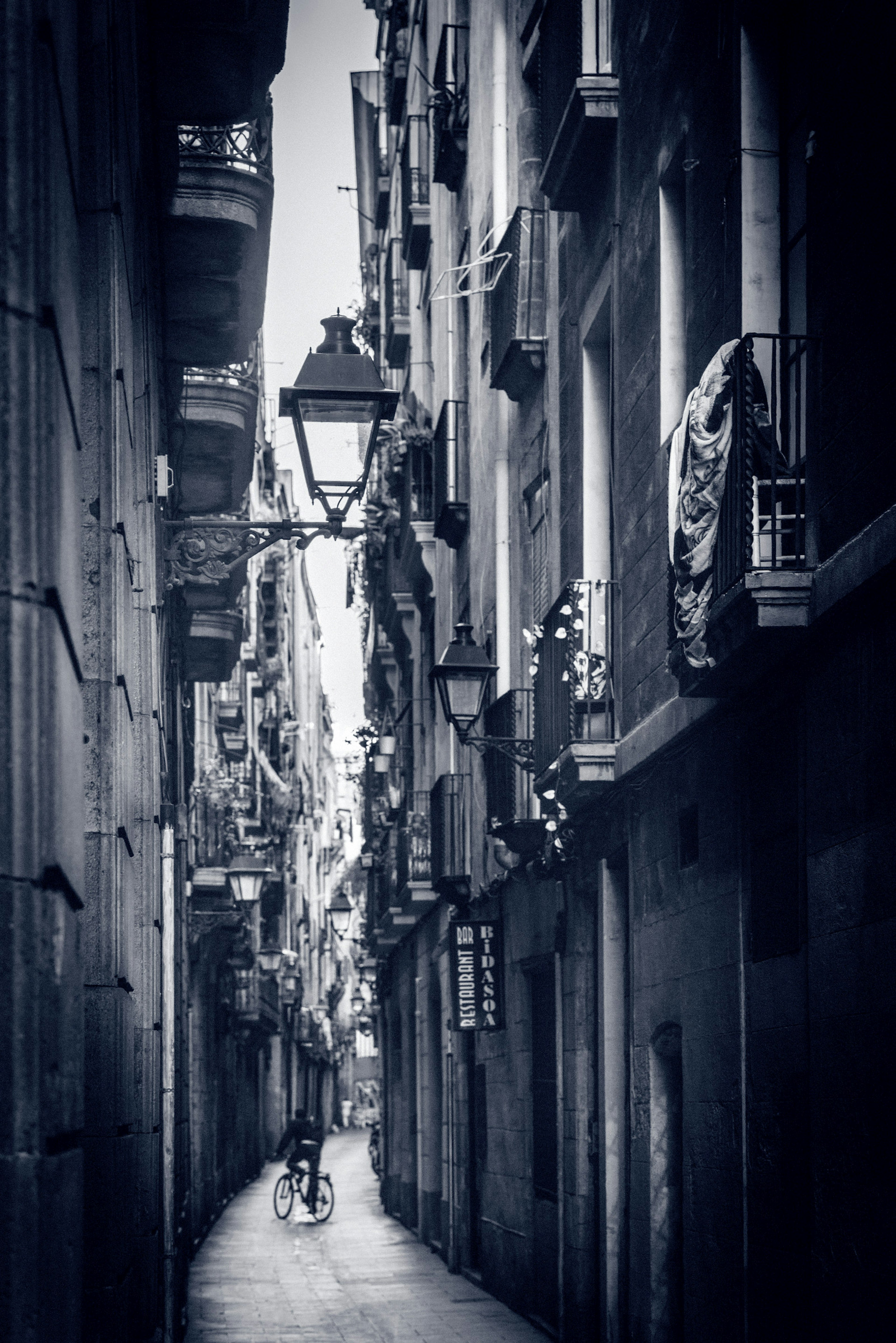 A black and white photo a street in the Barri Gotic © Jonathan Stokes / Lonely Planet