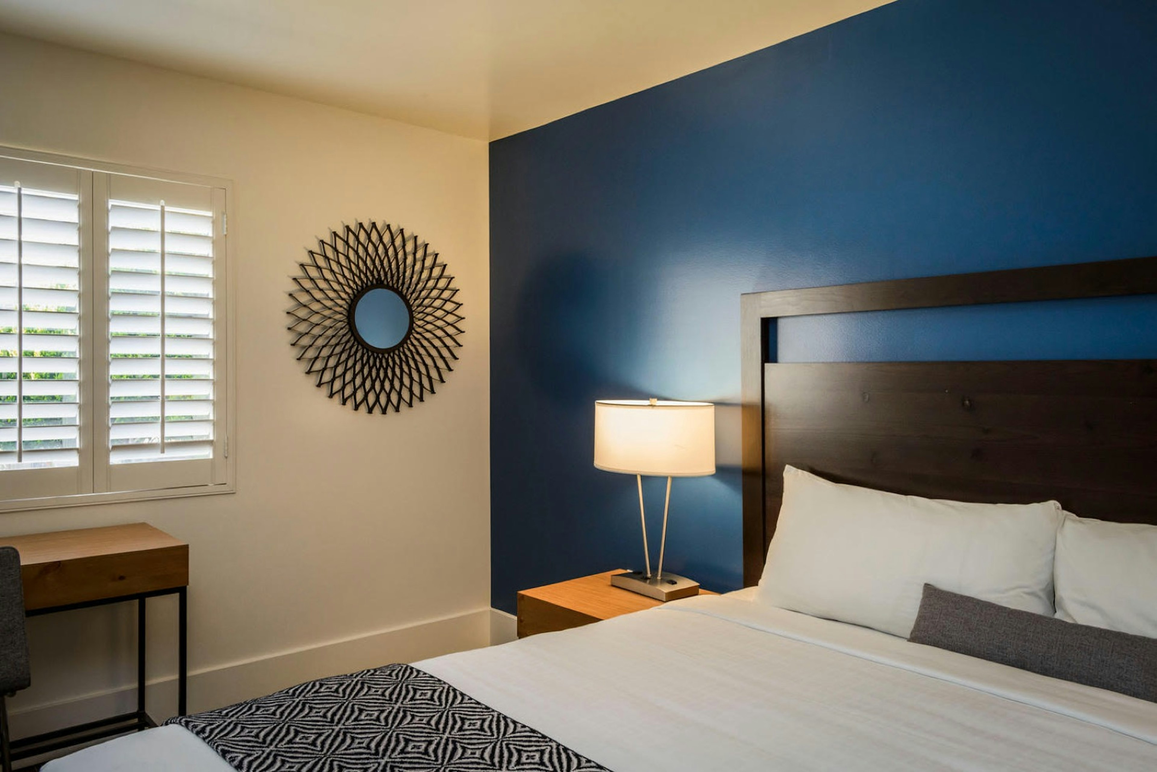 Interior of a room at Beck's, with a blue accent wall and modern furniture; coolest motels