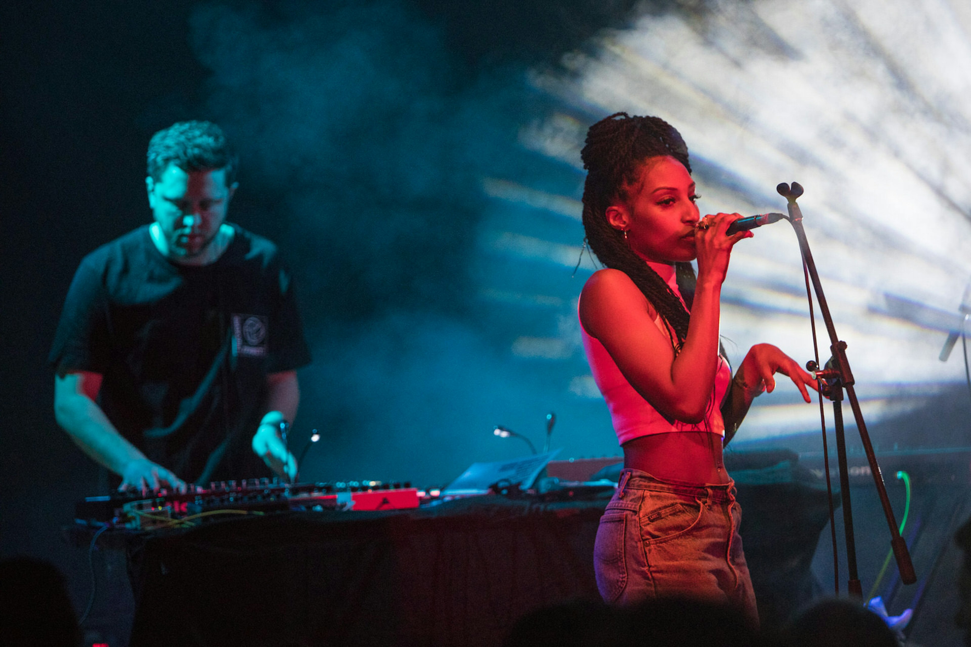 Berlin clubs - electronic musician George Fitzgerald and a singer of his live band perform live on stage during a concert at Schwuz in Berlin, Germany. The smoky stage is lit by red and blue lights