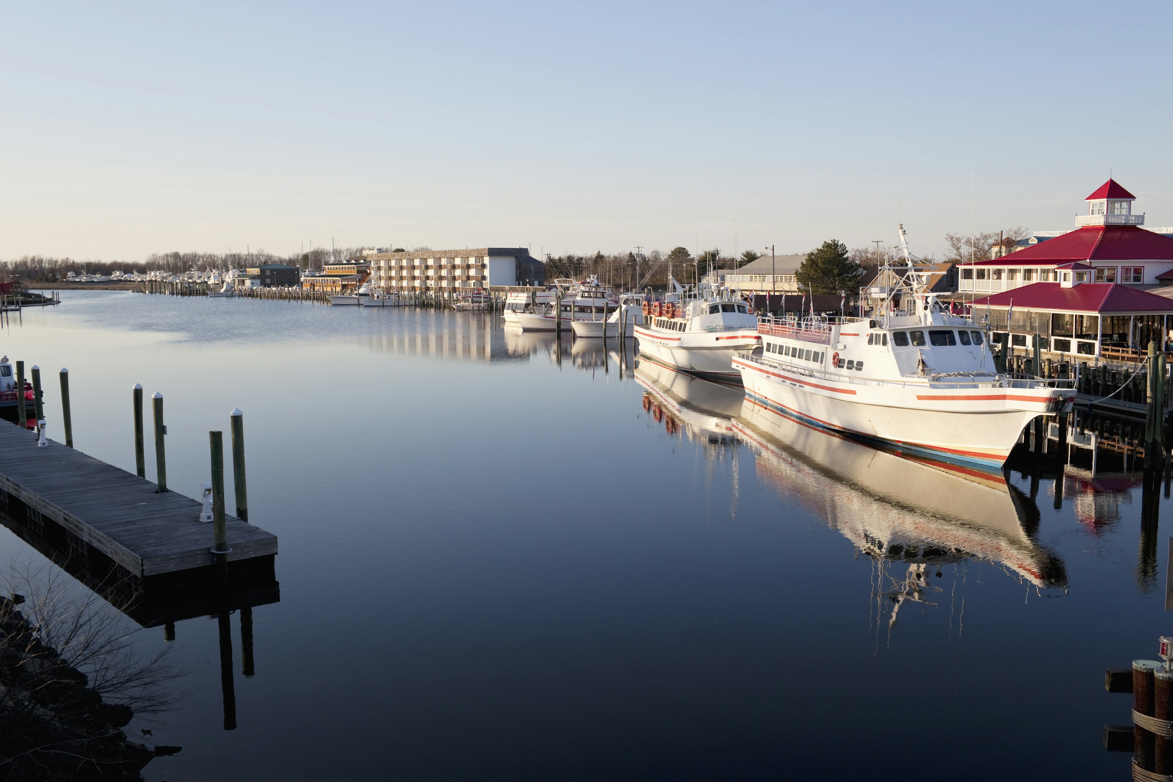 Boats docked on flat water near