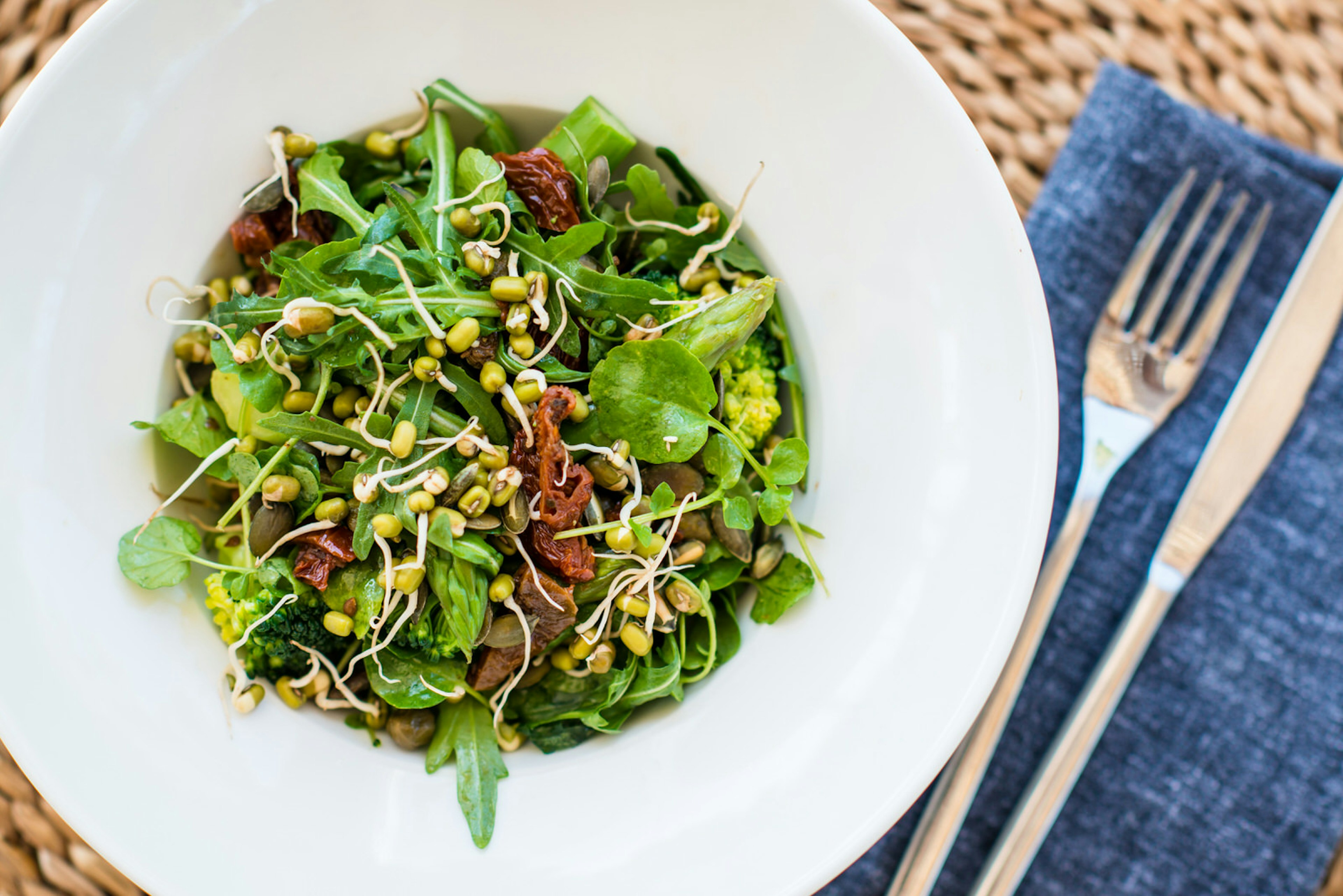 Ibiza spa breaks - a raw green salad at Body Camp Ibiza with leaves, seeds, beansprouts and sundried tomatoes served on a white plate