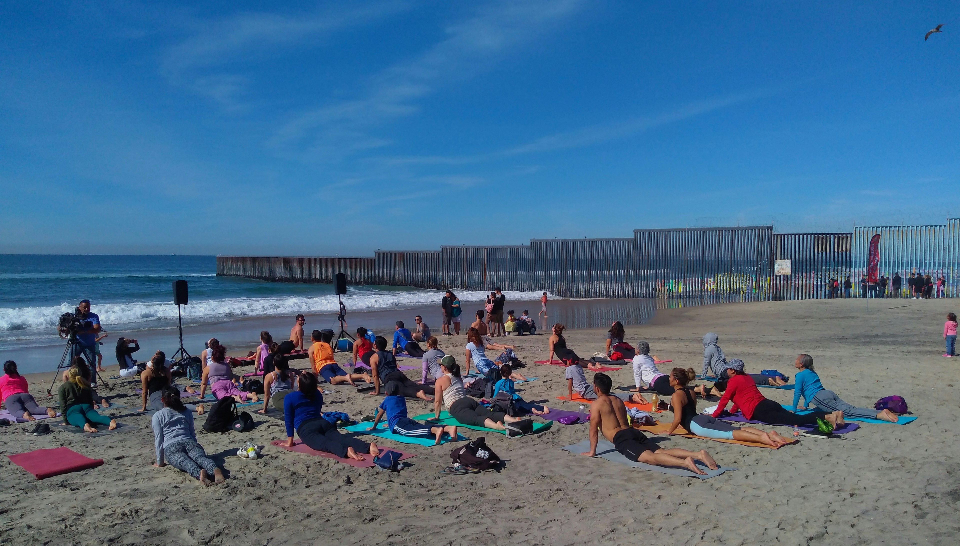 People practice yoga on the beach