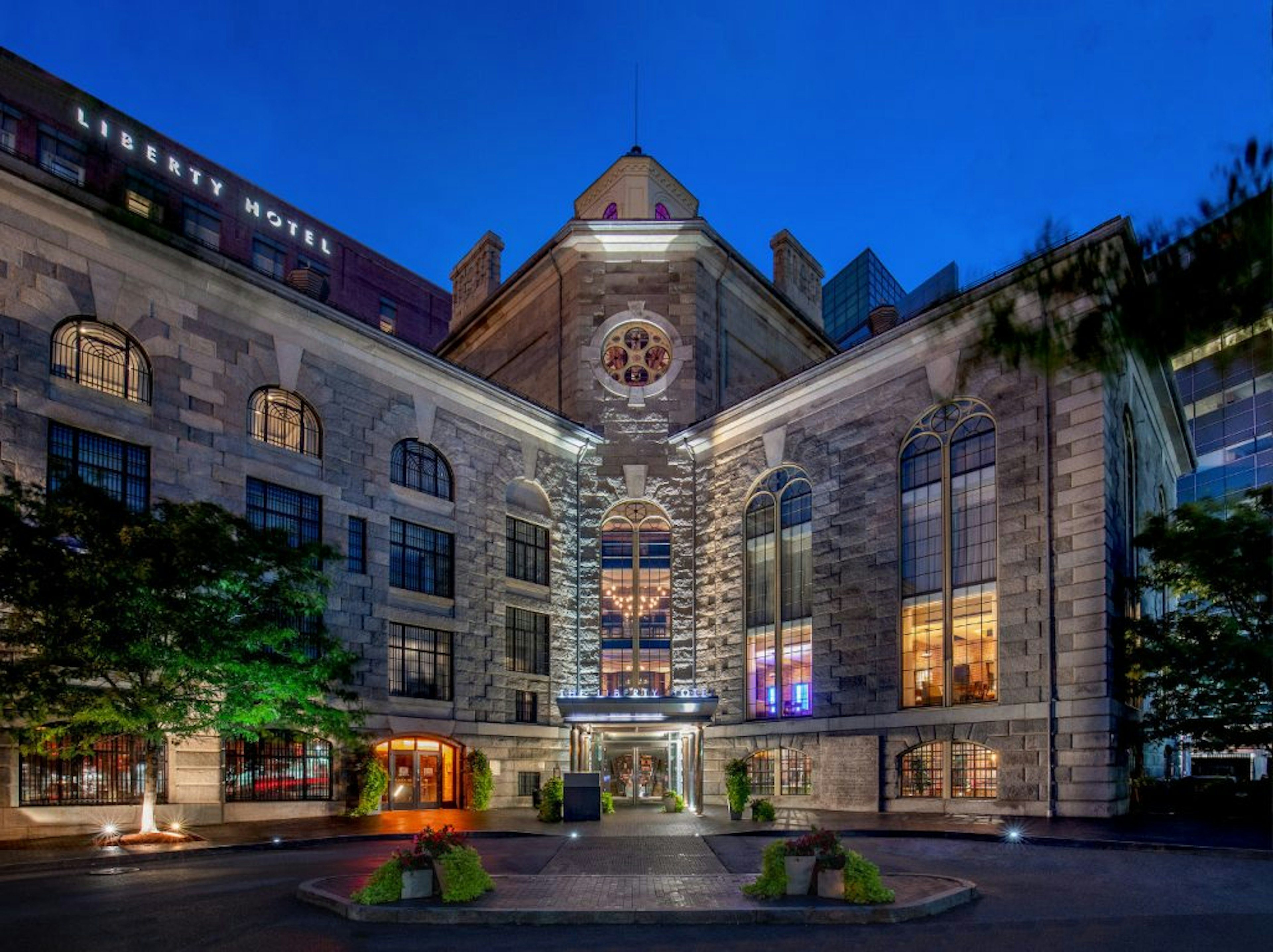 The exterior of the historic Liberty Hotel is lit up at night.