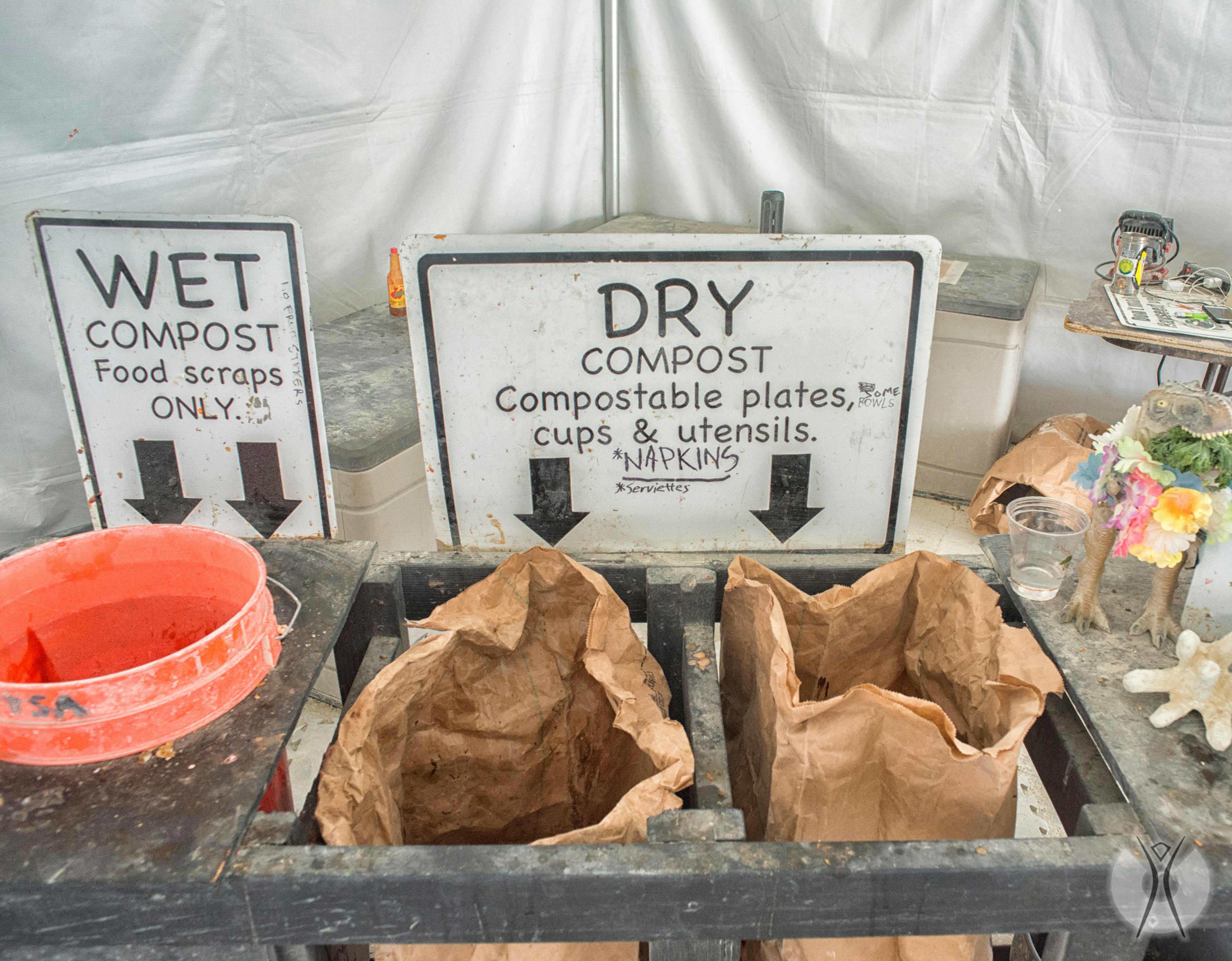 Different bags for composting are lined up at Burning Man festival.