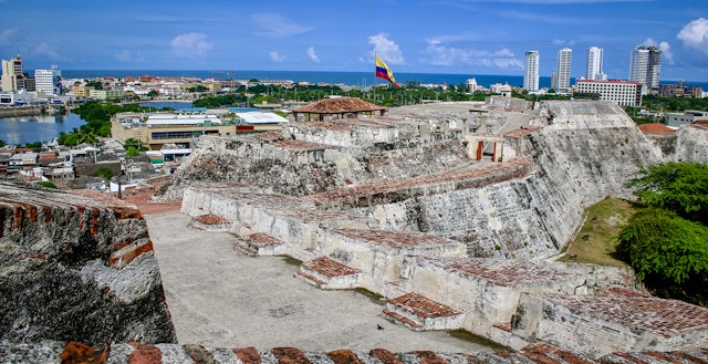 Spanish colonial fort surrounded by modern buildings in Cartagena © Jacqui de Klerk / Lonely Planet