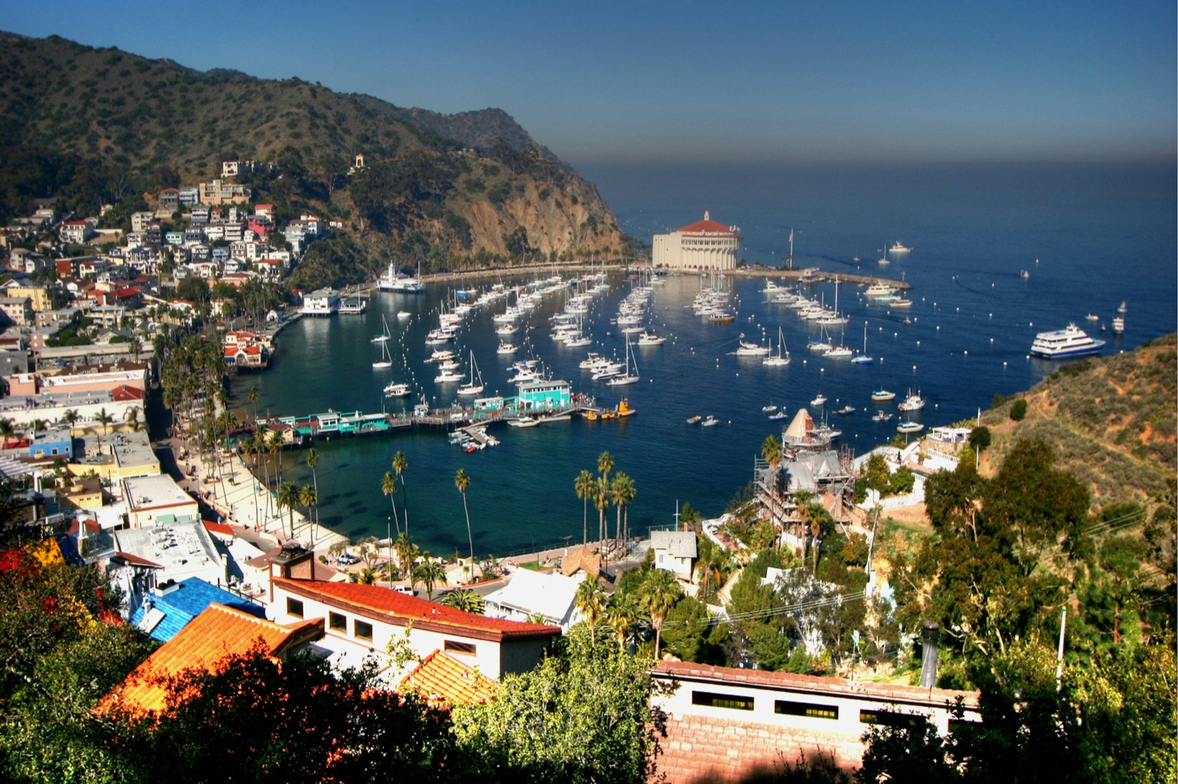 View of Avalon village, Catalina island, about 1 hour away from the California coast at Long Beach by catamaran. Midday view, the Los Angeles smog is visible along the horizon.