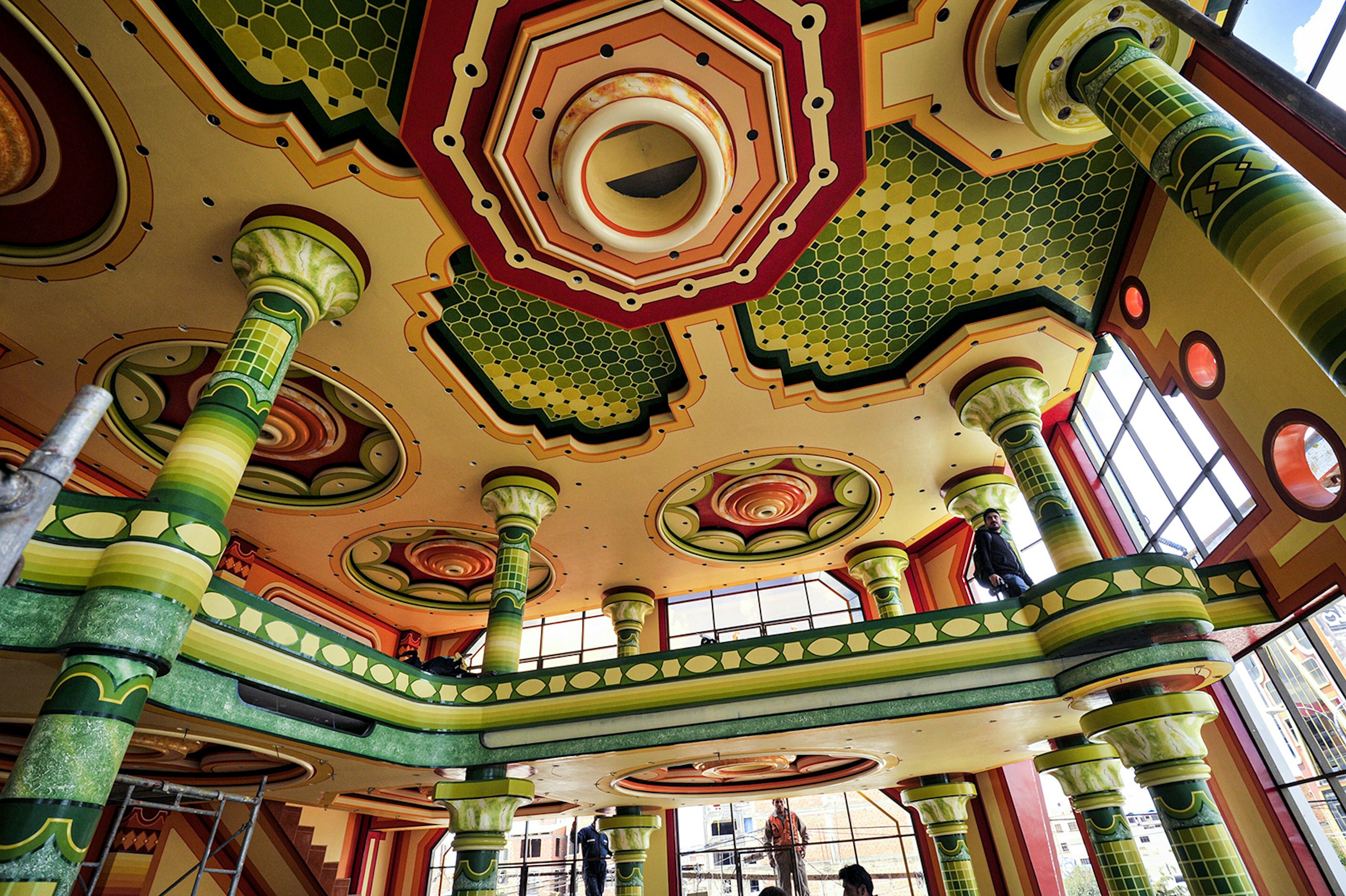 A colorful ceiling of a New Andean mansion features yellow, green, orange and red designs. La Paz, Bolivia.