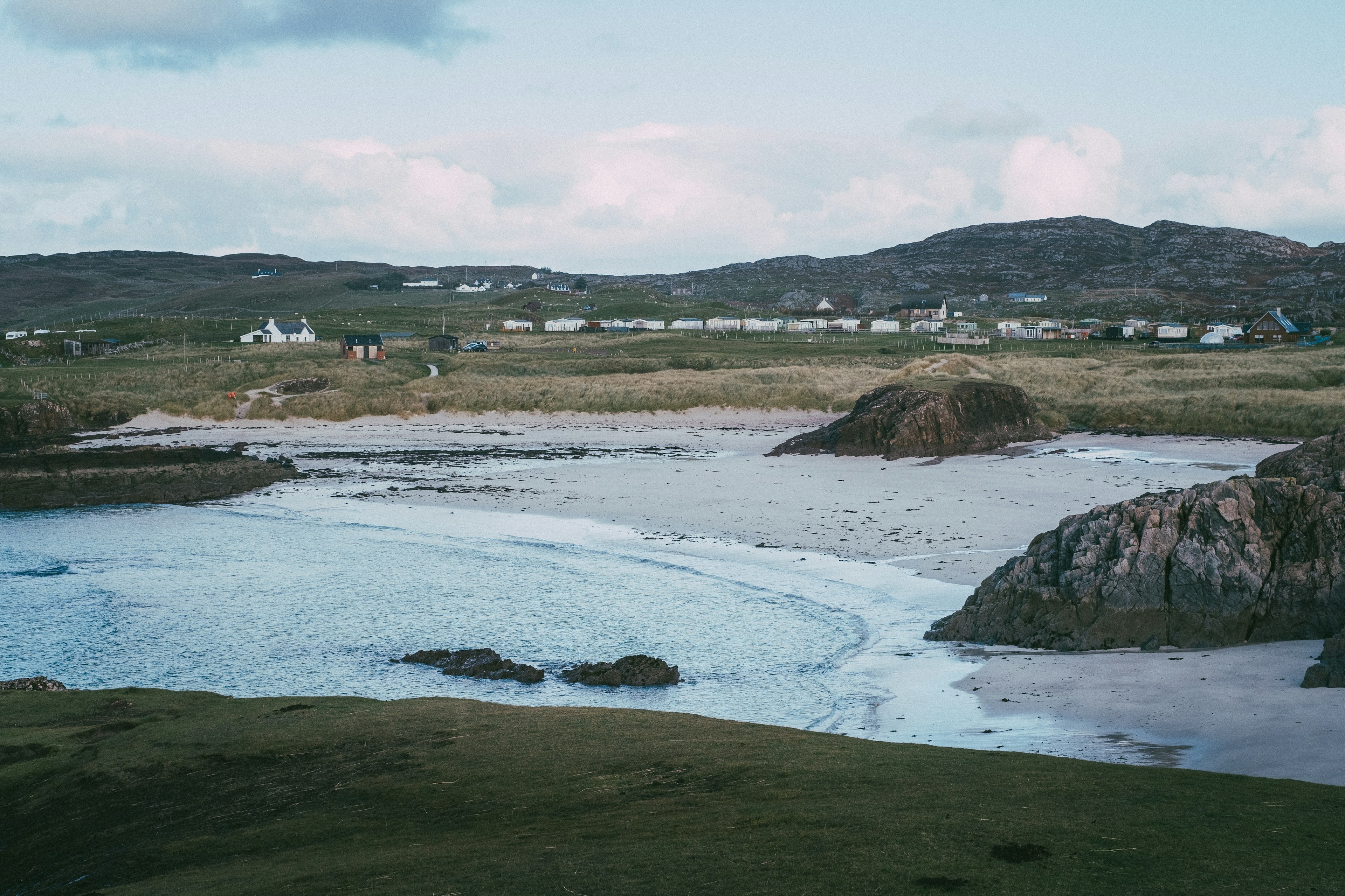 An empty, undisturbed Clachtoll Beach during daylight hours.