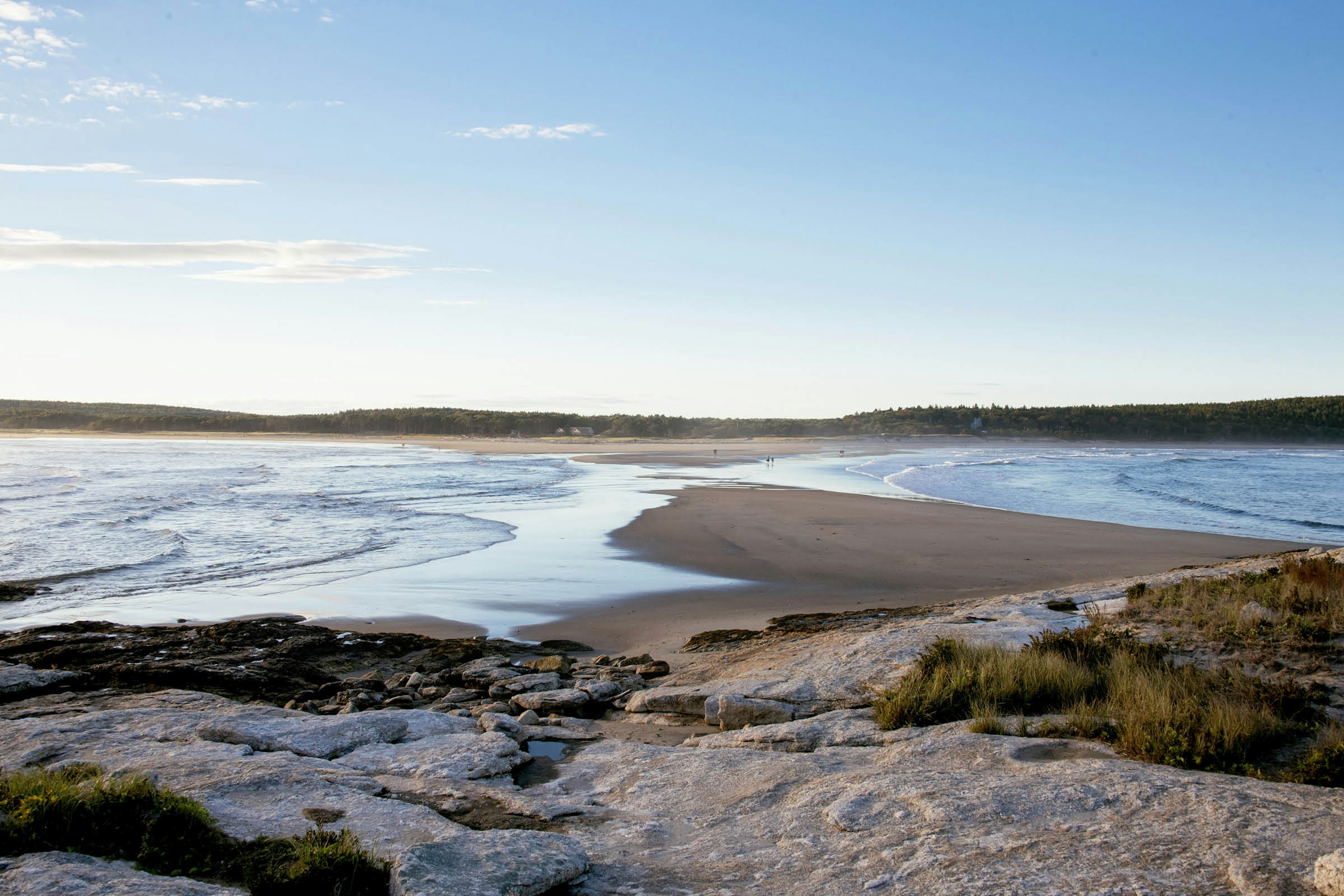 Waves lap either side of a narrow strip of sand at Popham Beach State Park