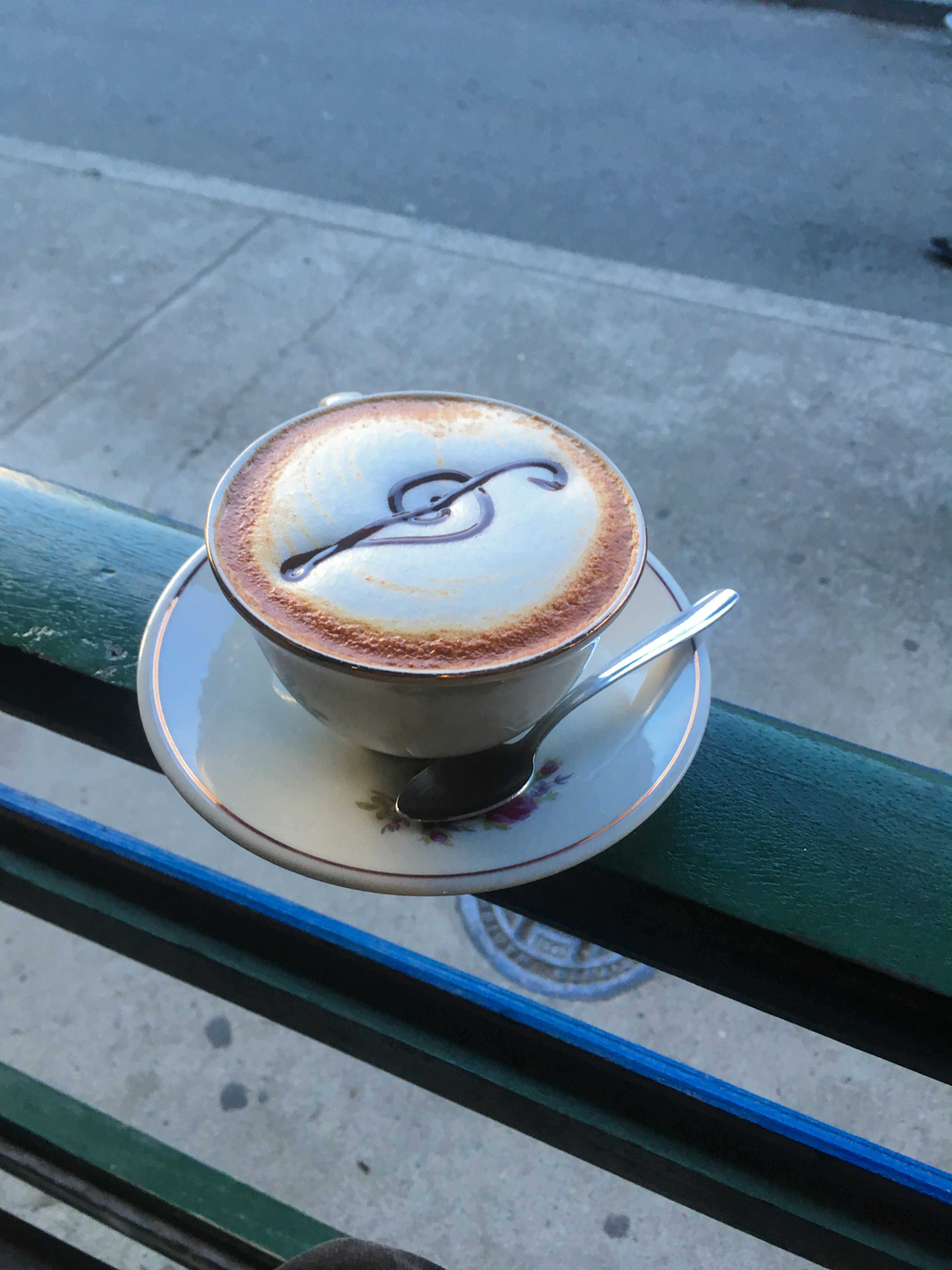 A cup of Colombian coffee with a treble clef drawn into the foam