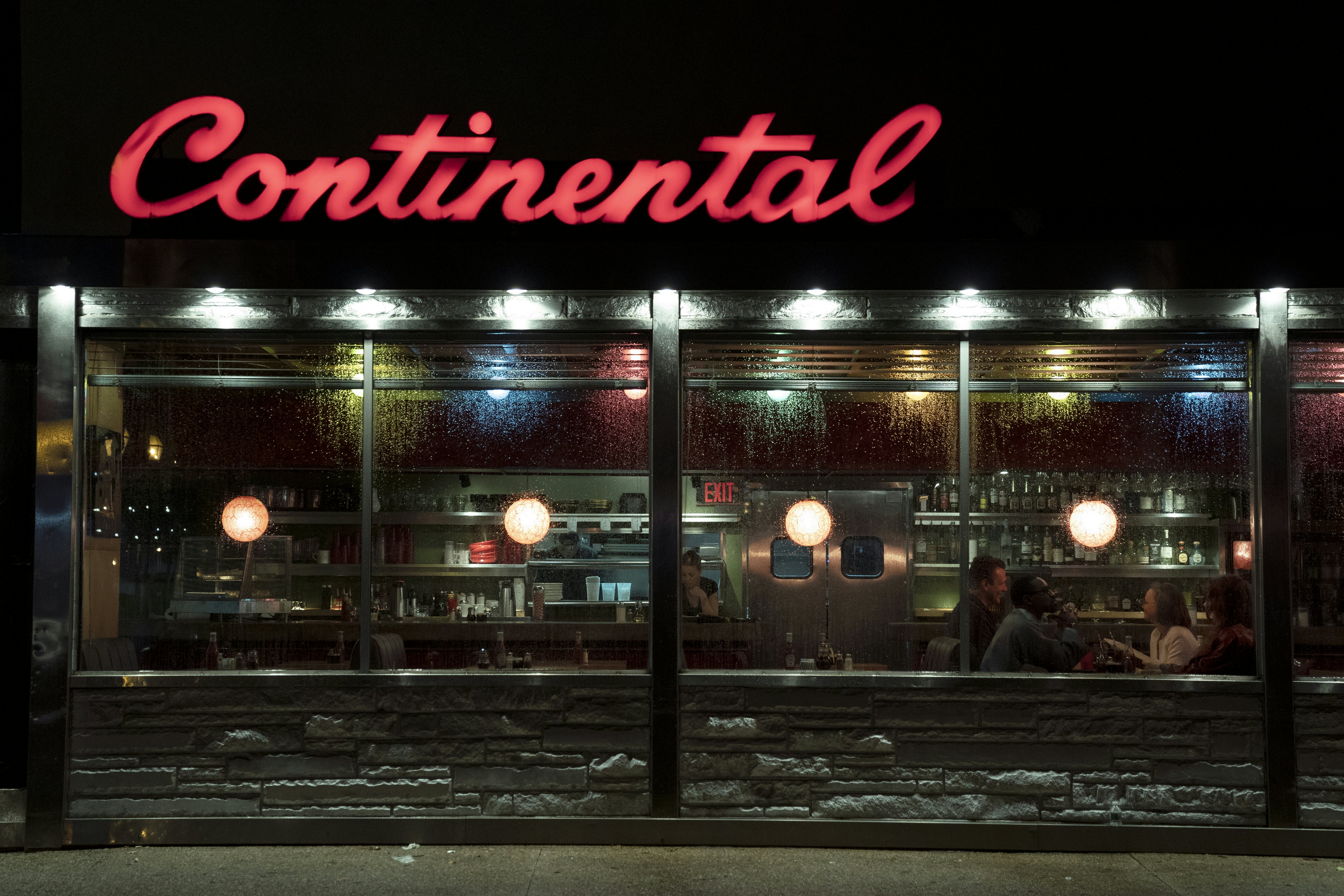 The outside of the Continental, in Philadelphia. The cast of AMC's Dispatches from Elsewhere are visible in the window