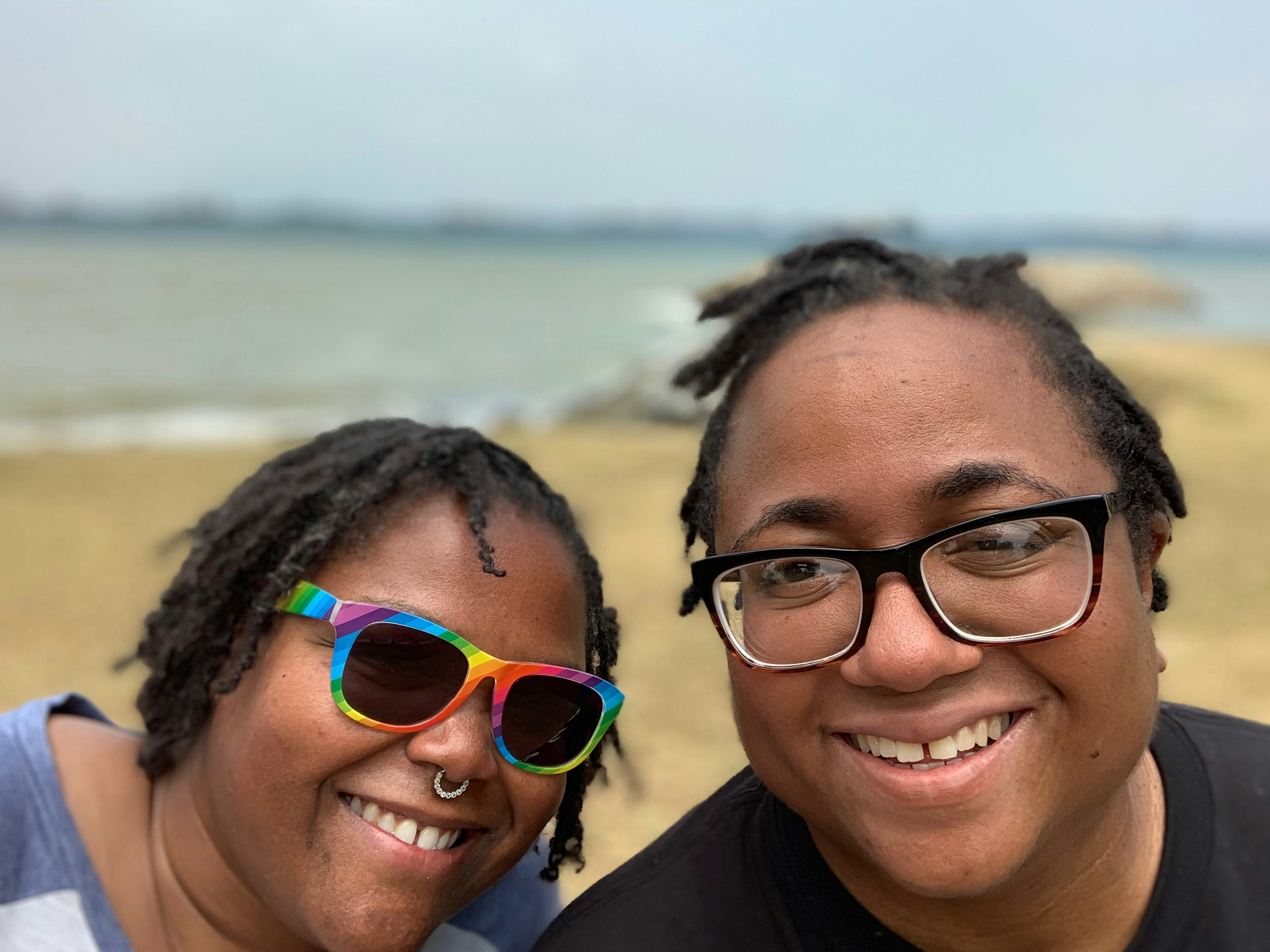 A pair of women smile on Singapore beach