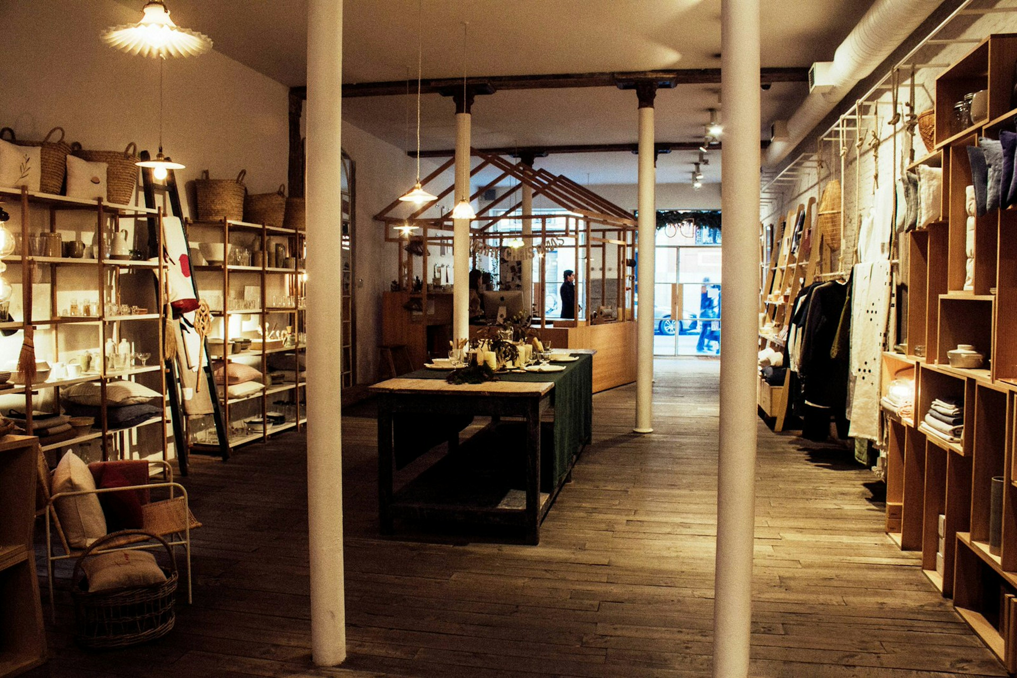 Interior of concept store Do Design, which is painted white and lined with shelves full of items on either wall