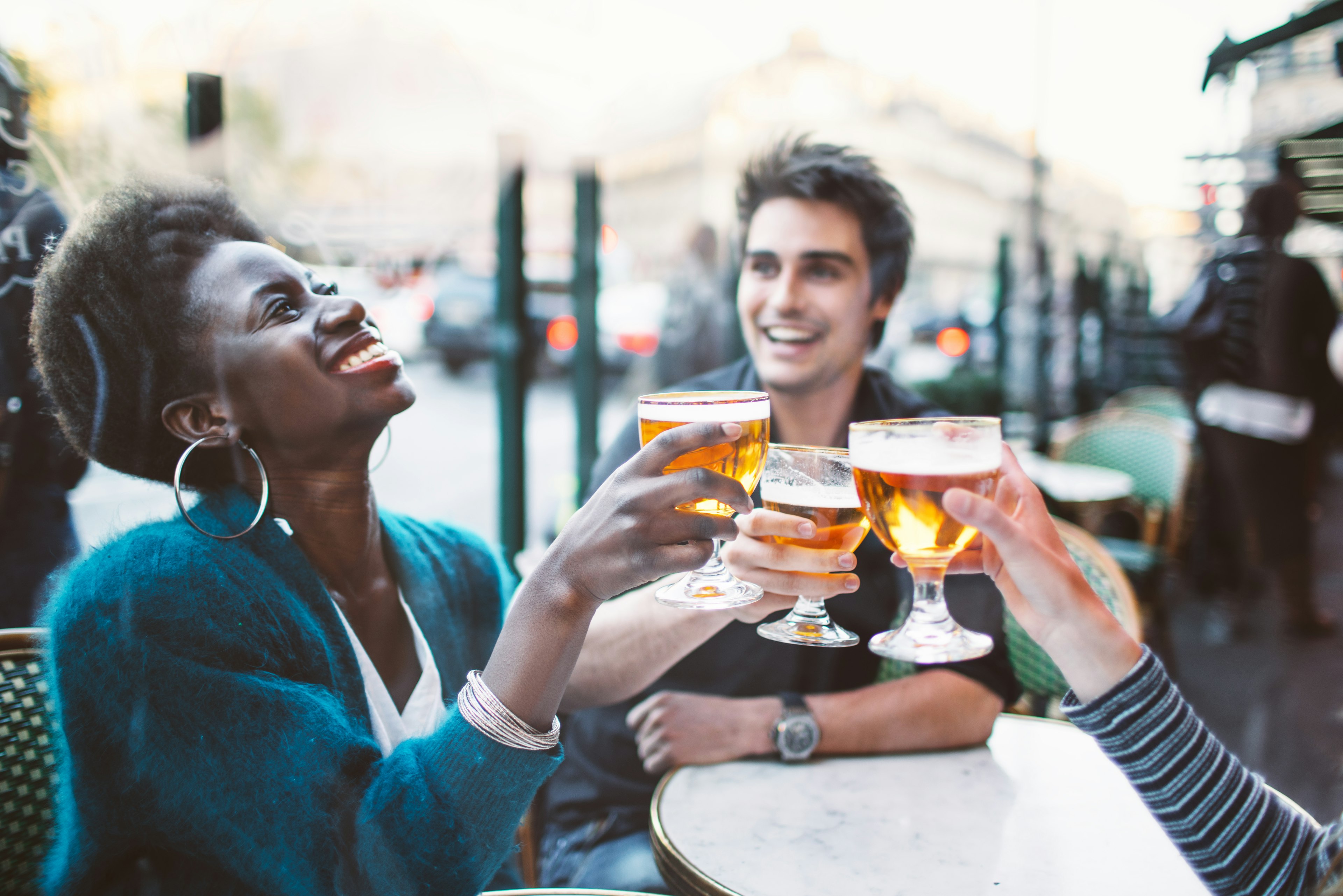 Group of friends drinking beer at a cafe.