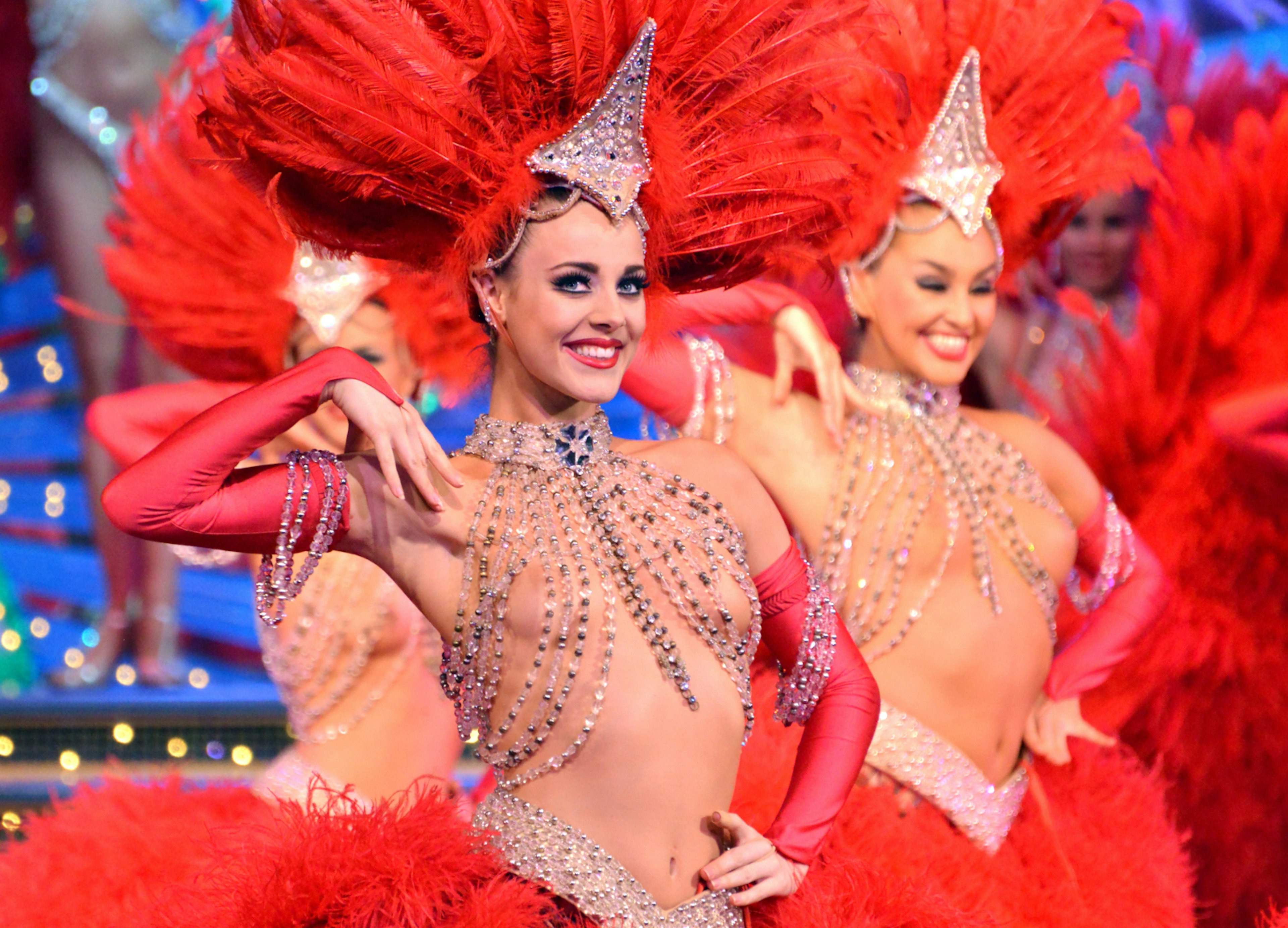 With a sequined top and red head dress Claudine, the Principal Dancer at the Moulin Rouge strikes a pose onstage