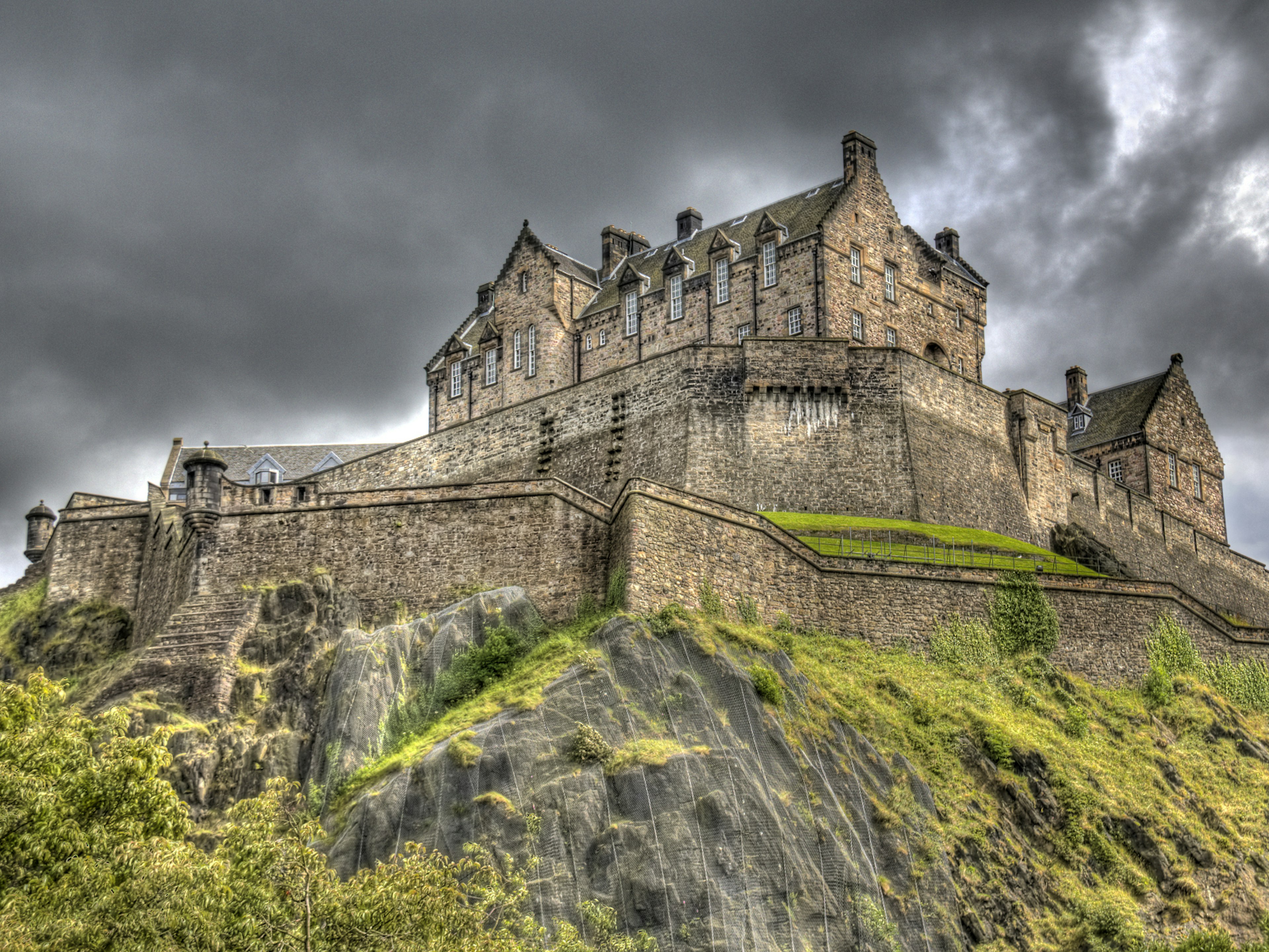 Looking up to Edinburgh Castle with stormy skies in the background