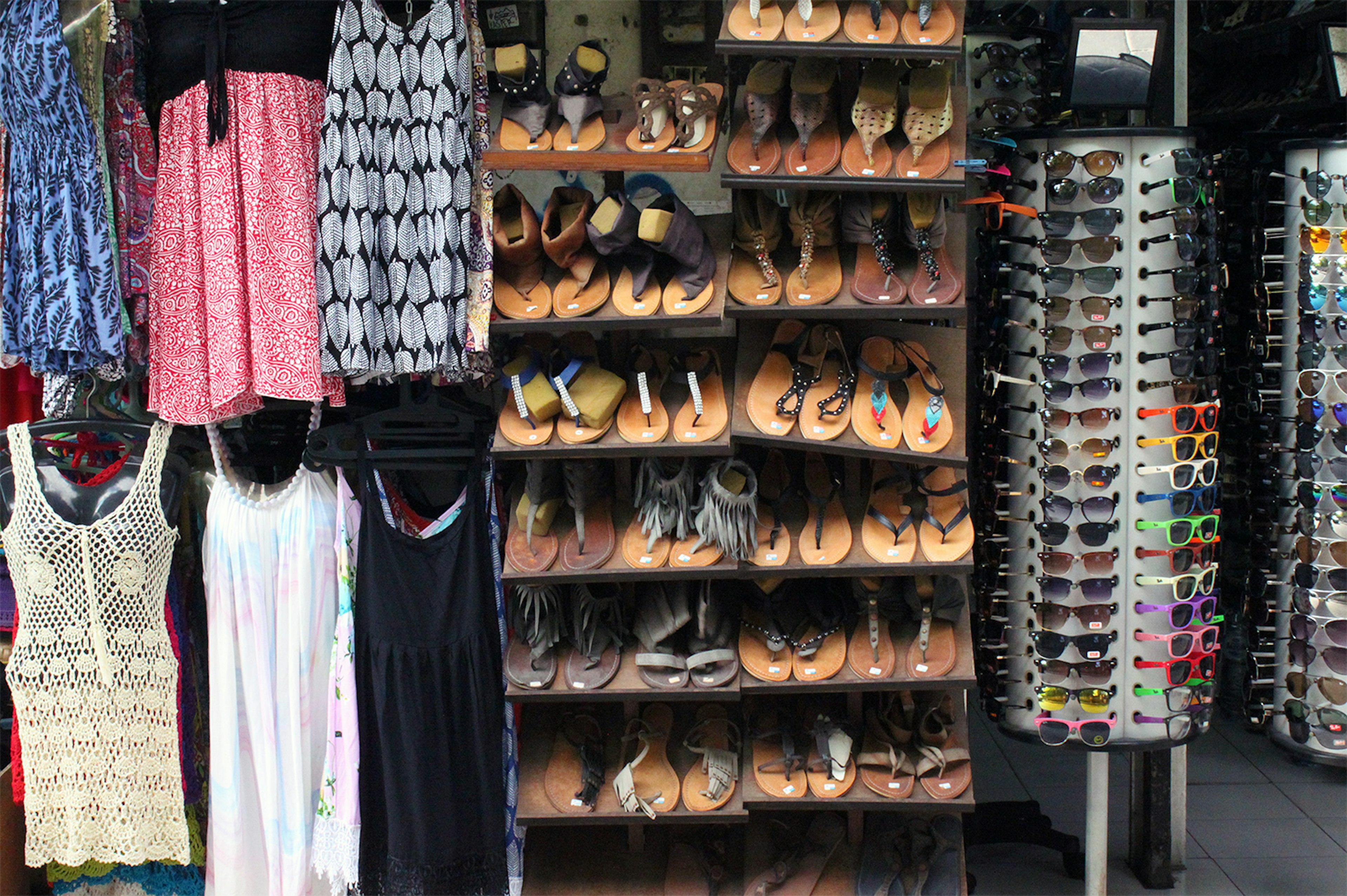 Endless rows of budget clothing, sunglasses and tourist trinkets on Poppies Gang I in Kuta, Bali. Image by Samantha Chalker / Lonely Planet