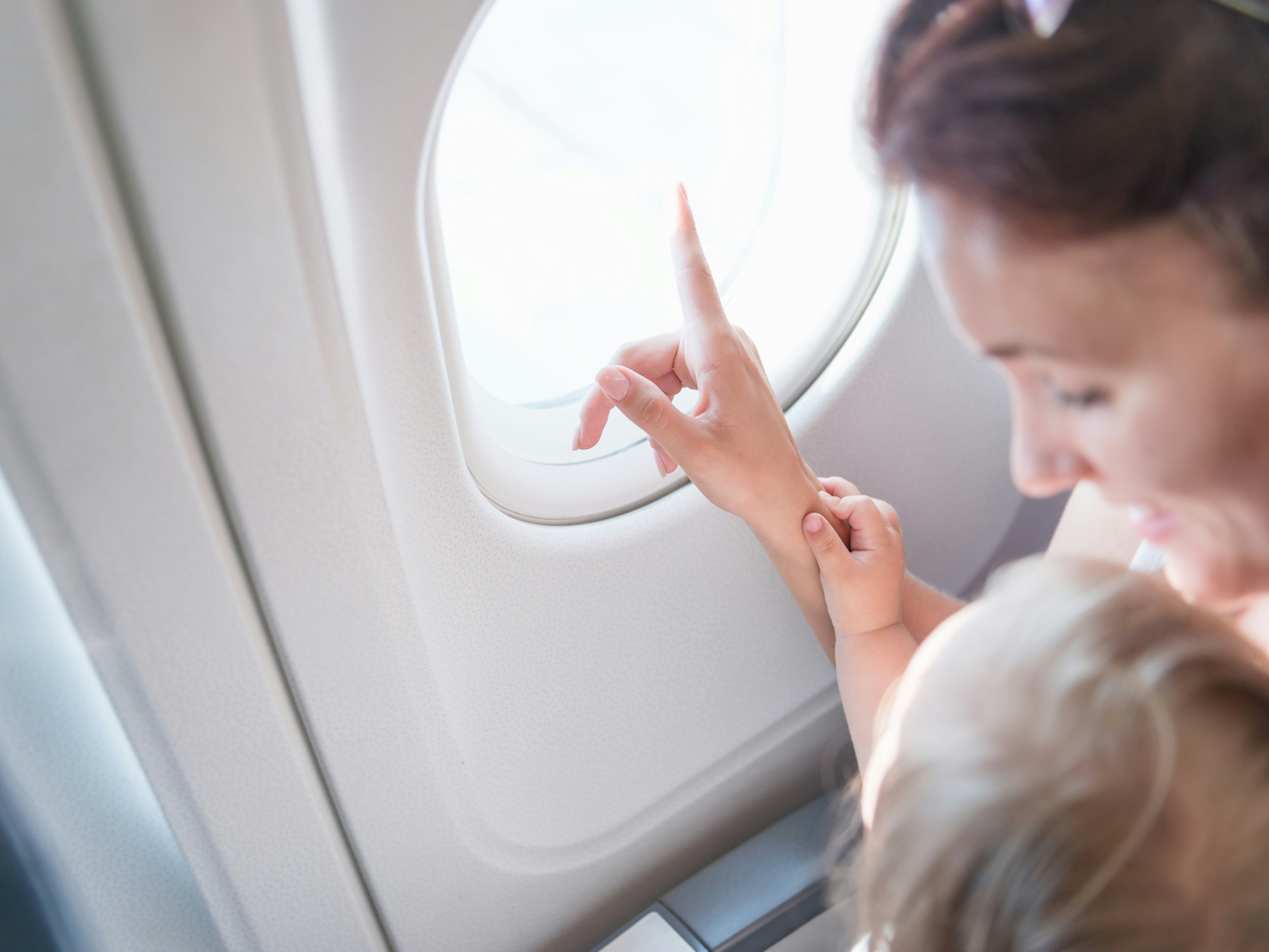 Mum and baby looking out of a plane window