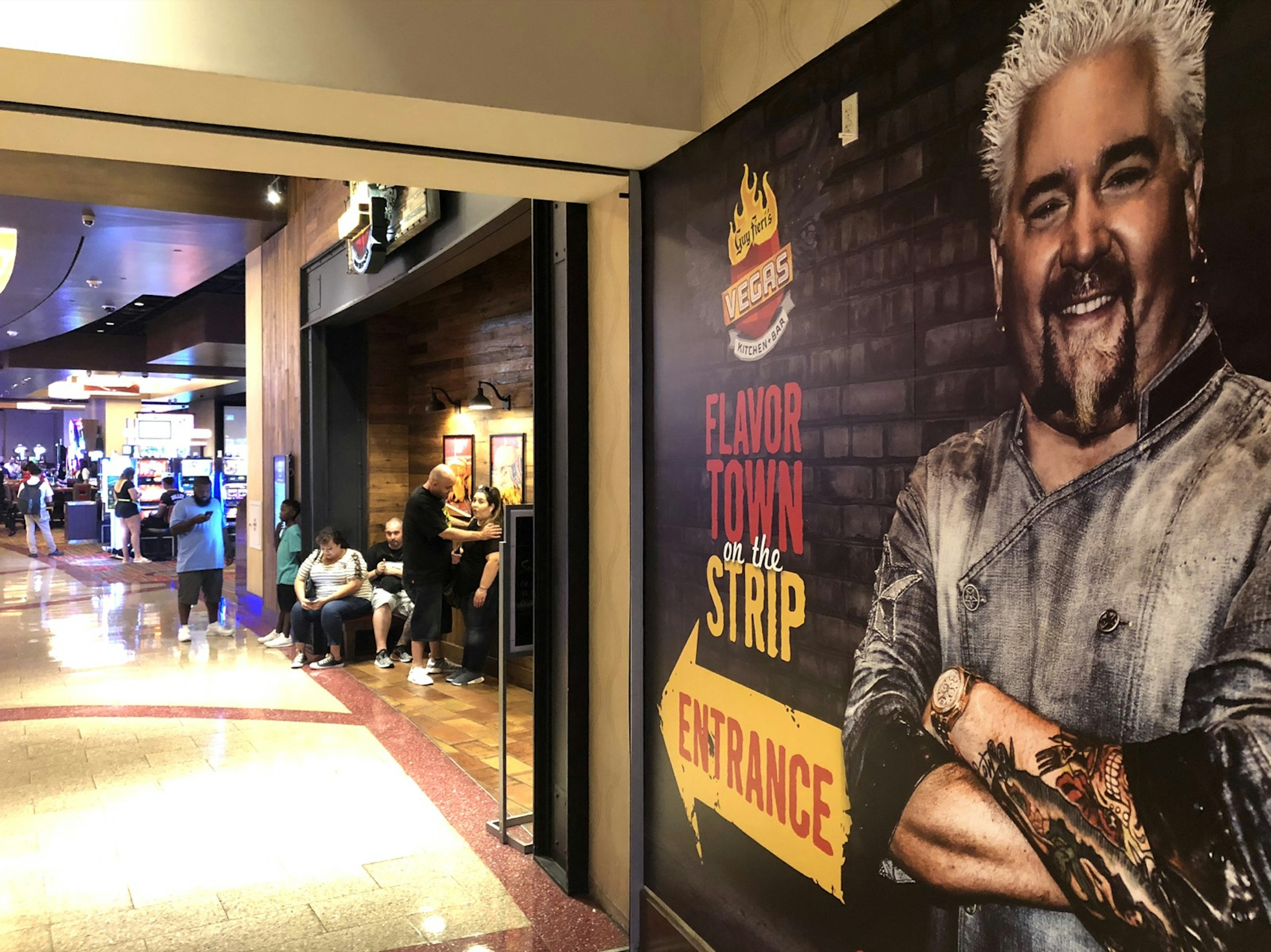 A large mural of celebrity chef Guy Fieri points the way to his restaurant in a Las Vegas casino