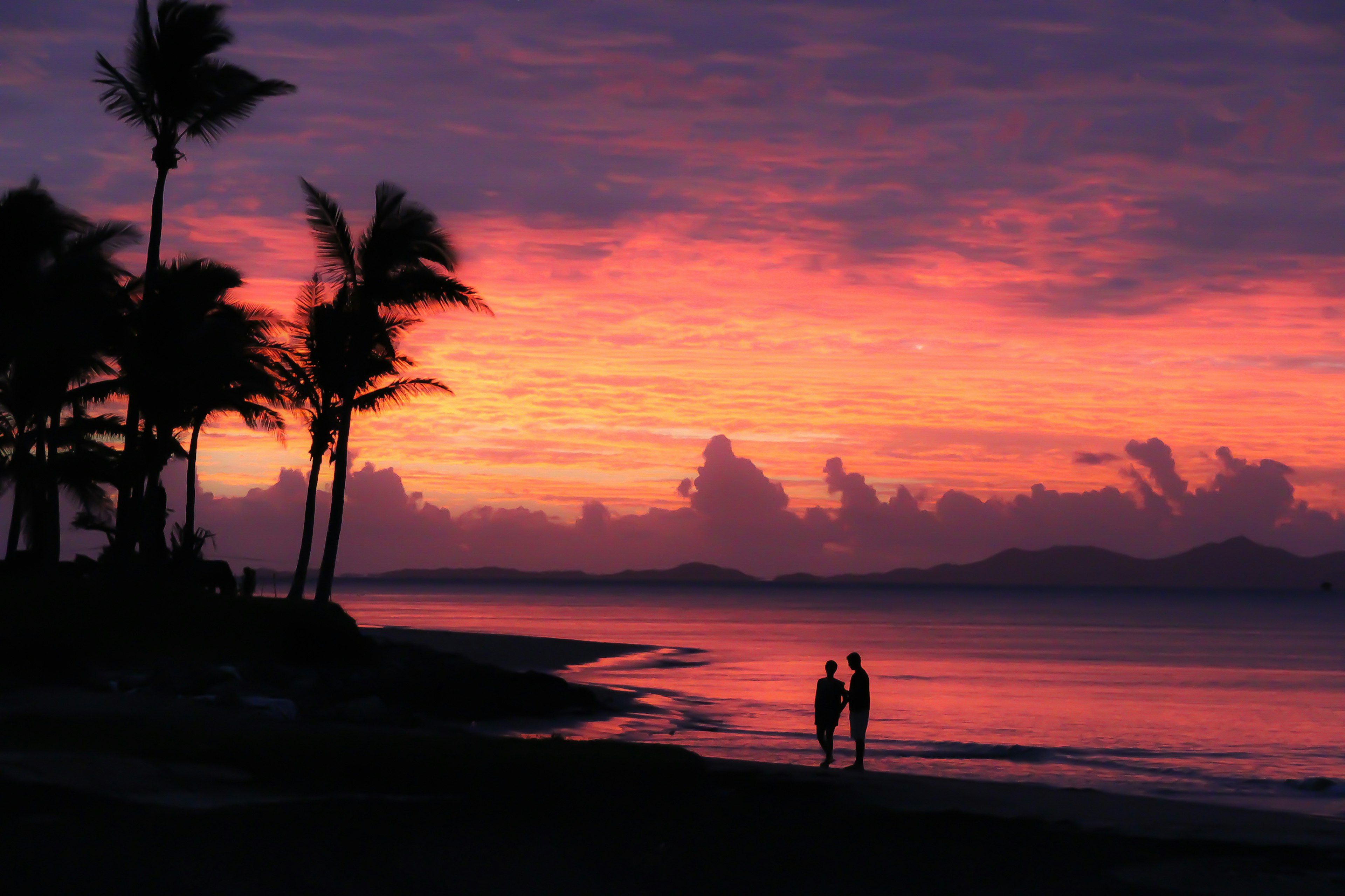 A couple enjoy the sunset on Denarau island in Fiji. Getty Images