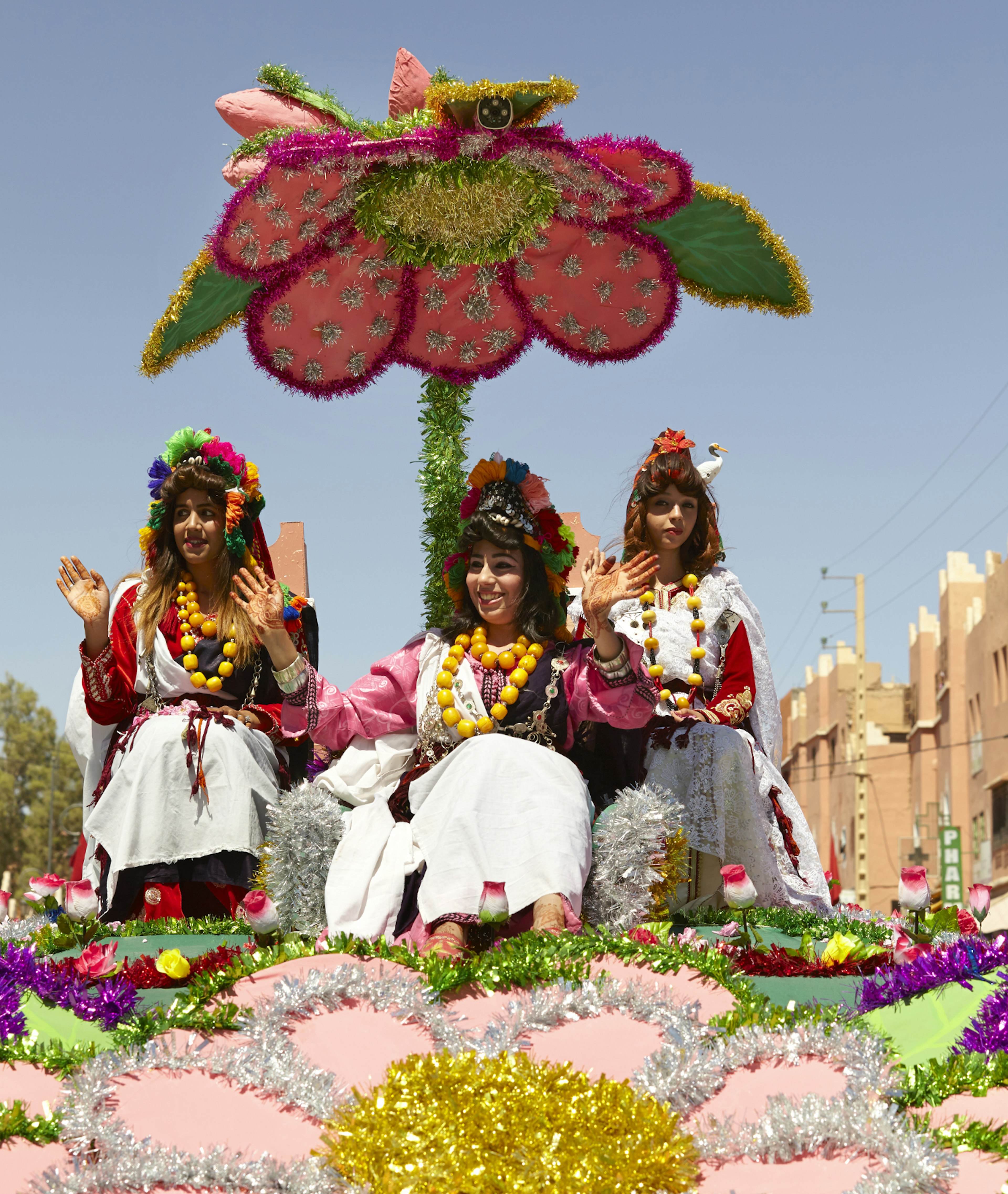 The Rose Queen with second runner up (far right) and third runner up (left) behind her, is processed through the town of Kalaat M'Gouna, Morocco, on the last day of the Rose Festival, waving to thousands of visitors lining the streets