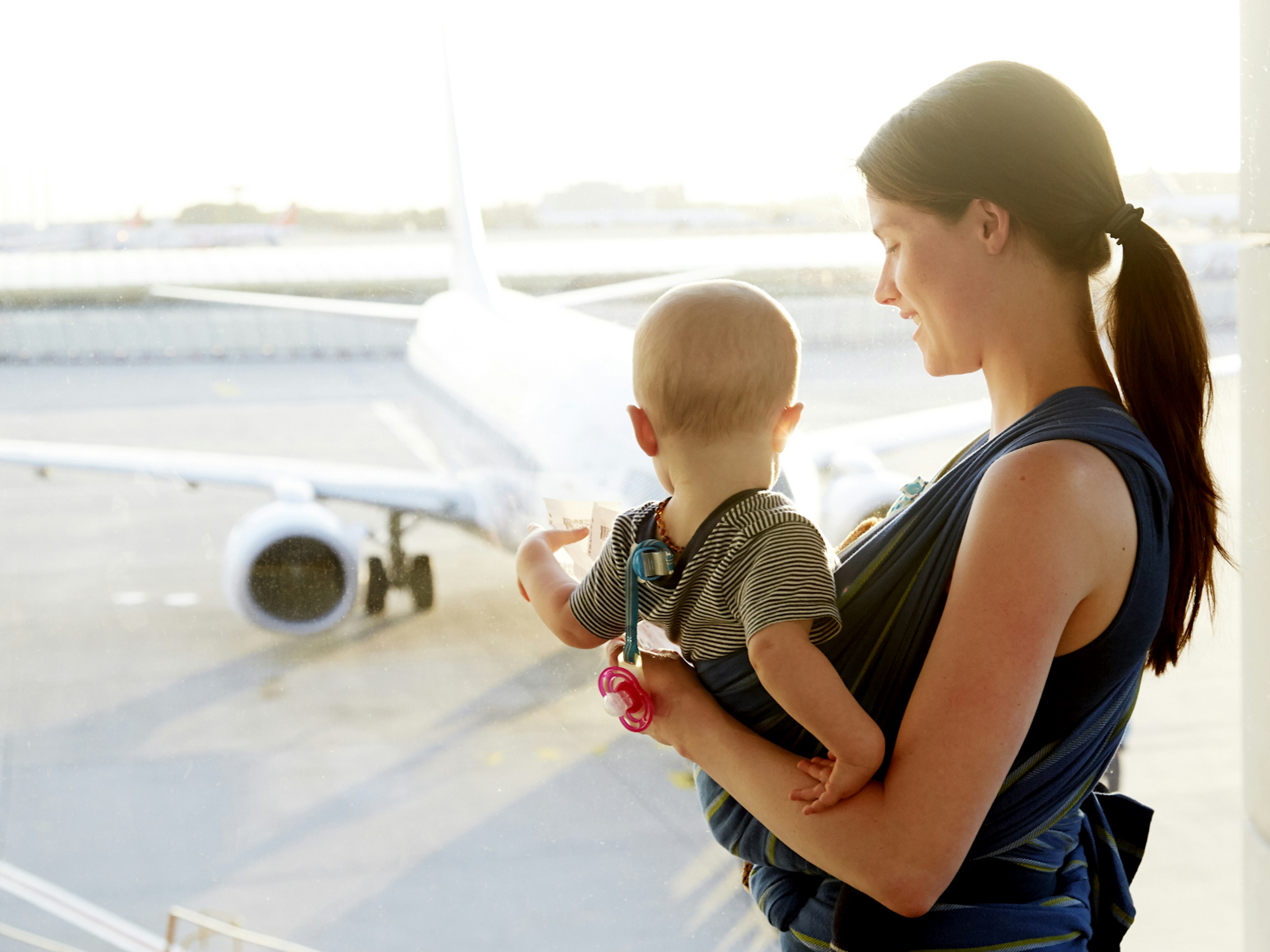 A woman with her baby at an airport