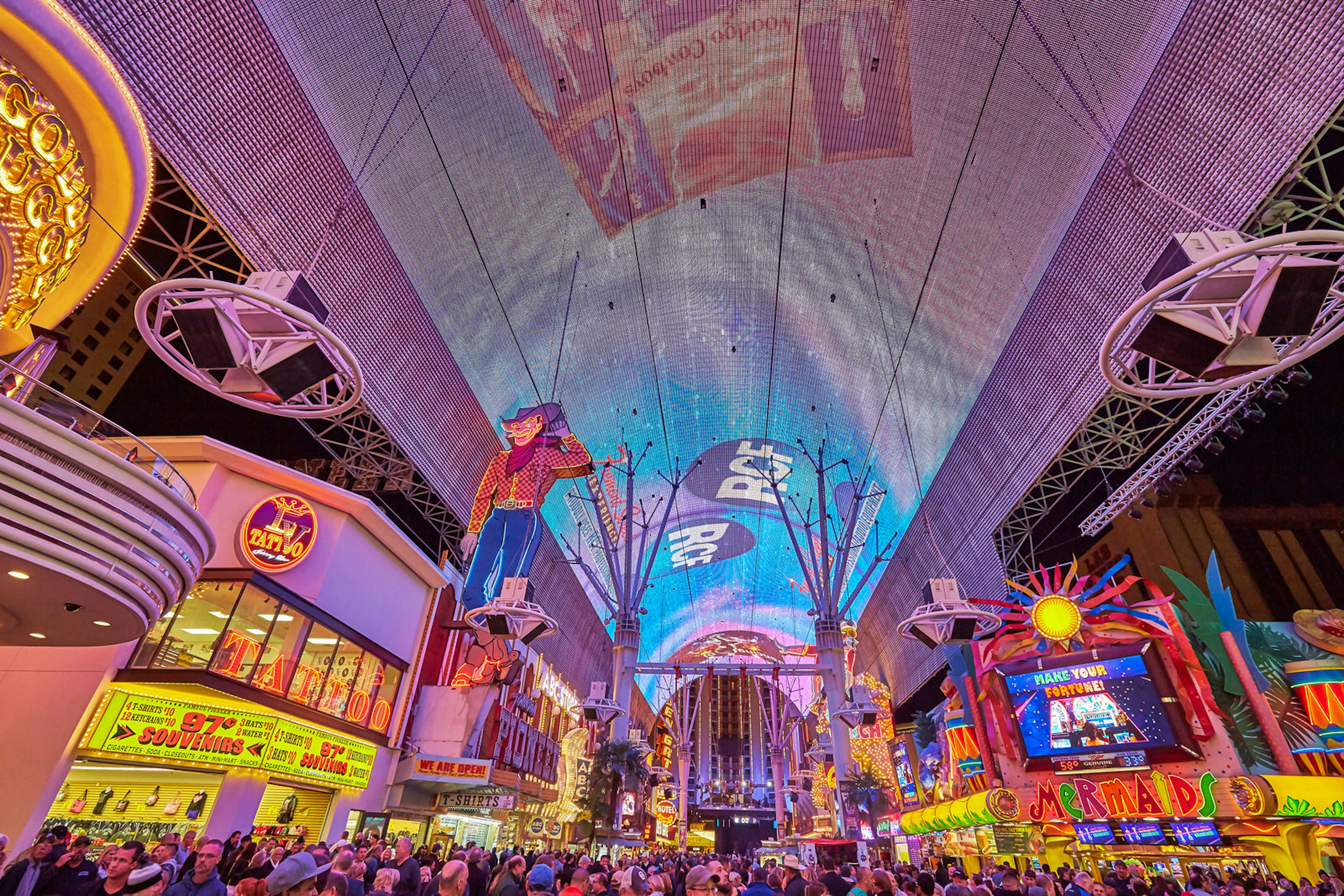 A riot of neon lights and signs covers both sides of the street, while a massive LED ceiling project moving images overhead © Peter Unger / Getty Images