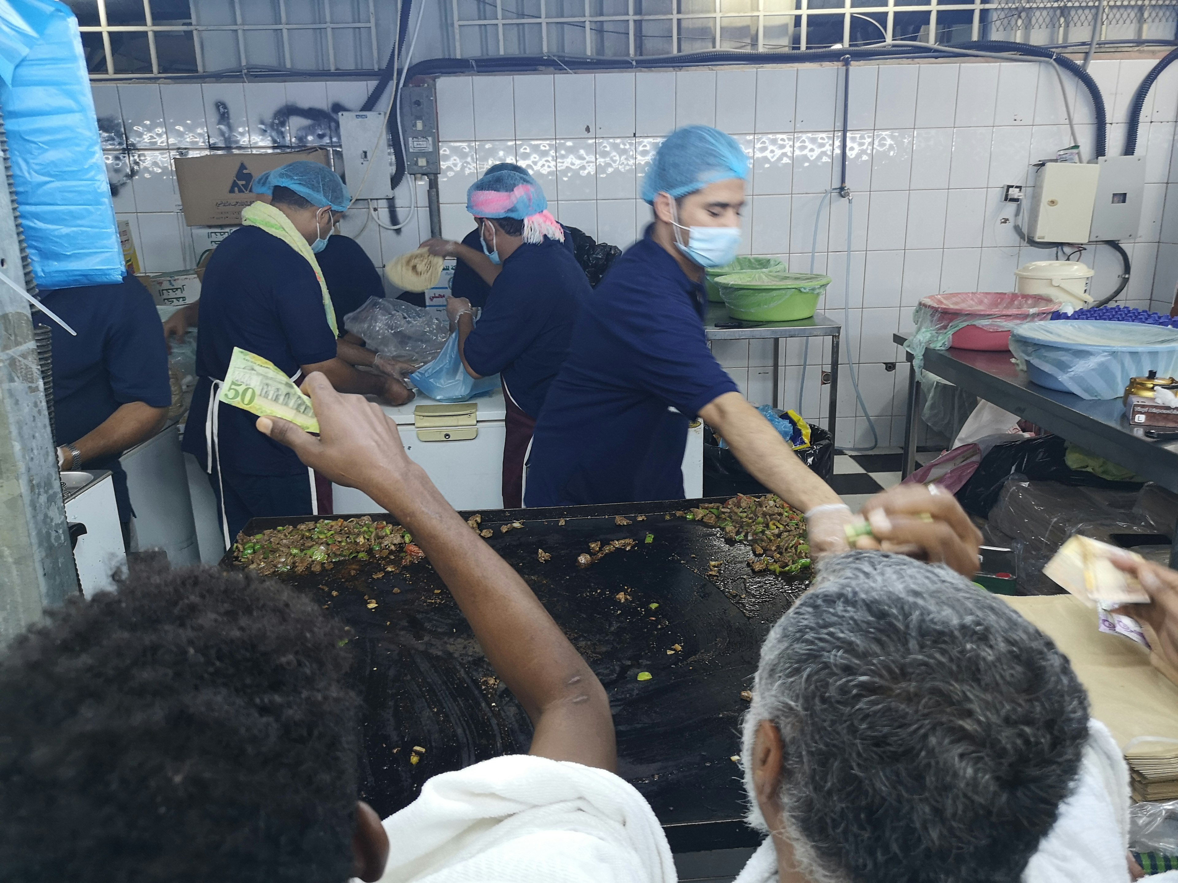 Fried liver store in Min with a queue of people buying food