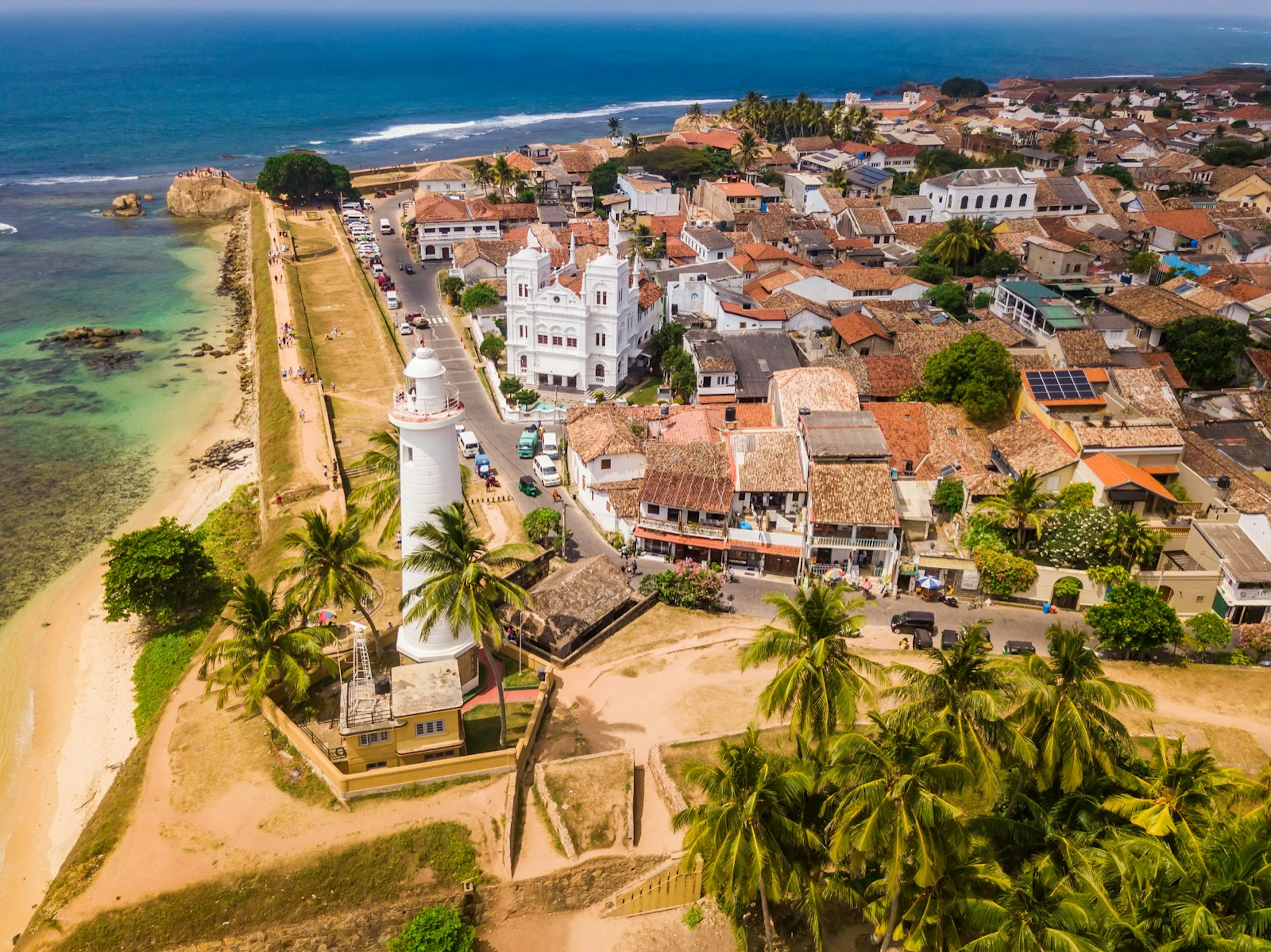 A walled city on the shore of a blue ocean