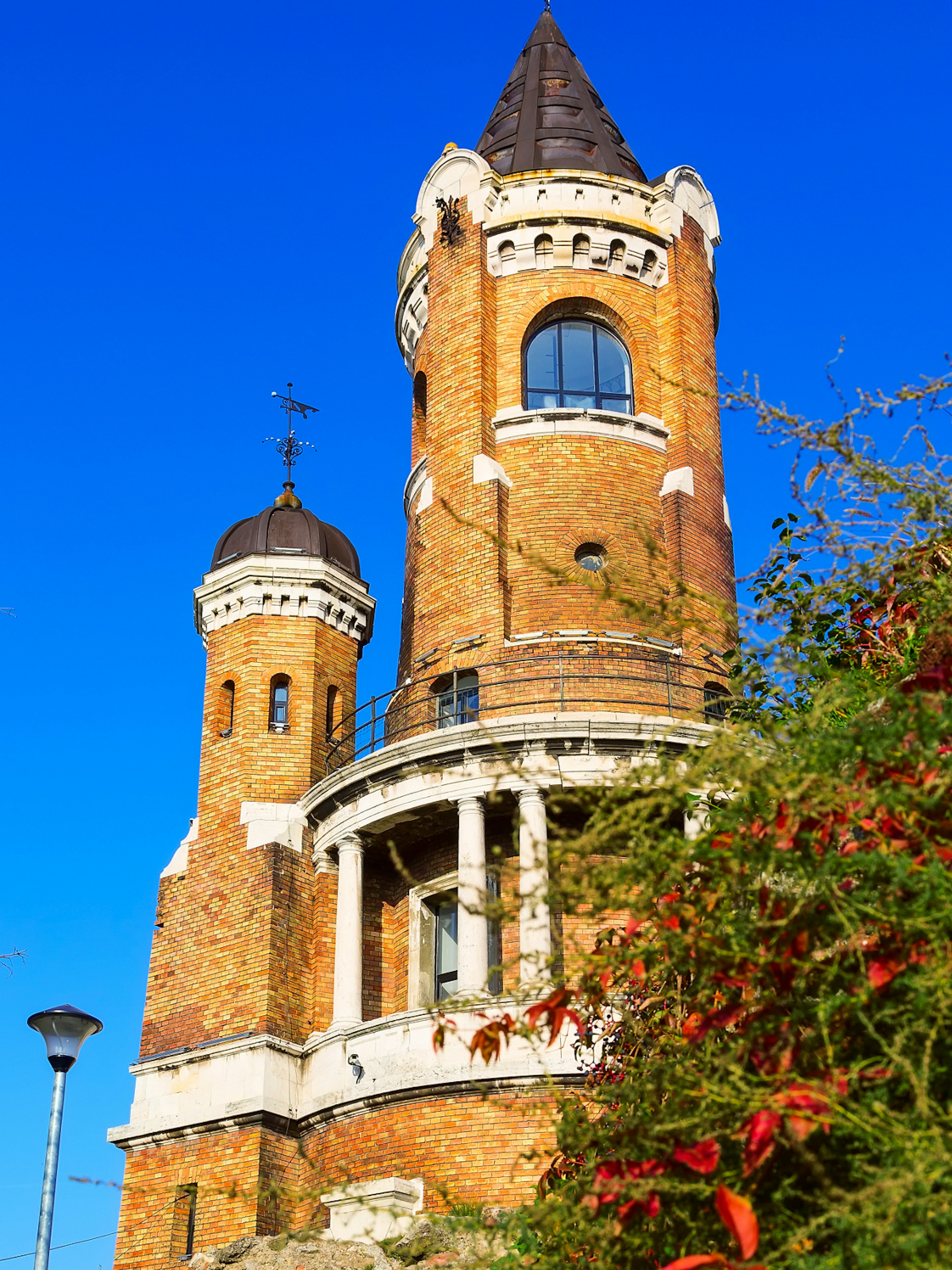 The tall, round, red-brick and white-stone Ҳš tower in Zemun neighbourhood