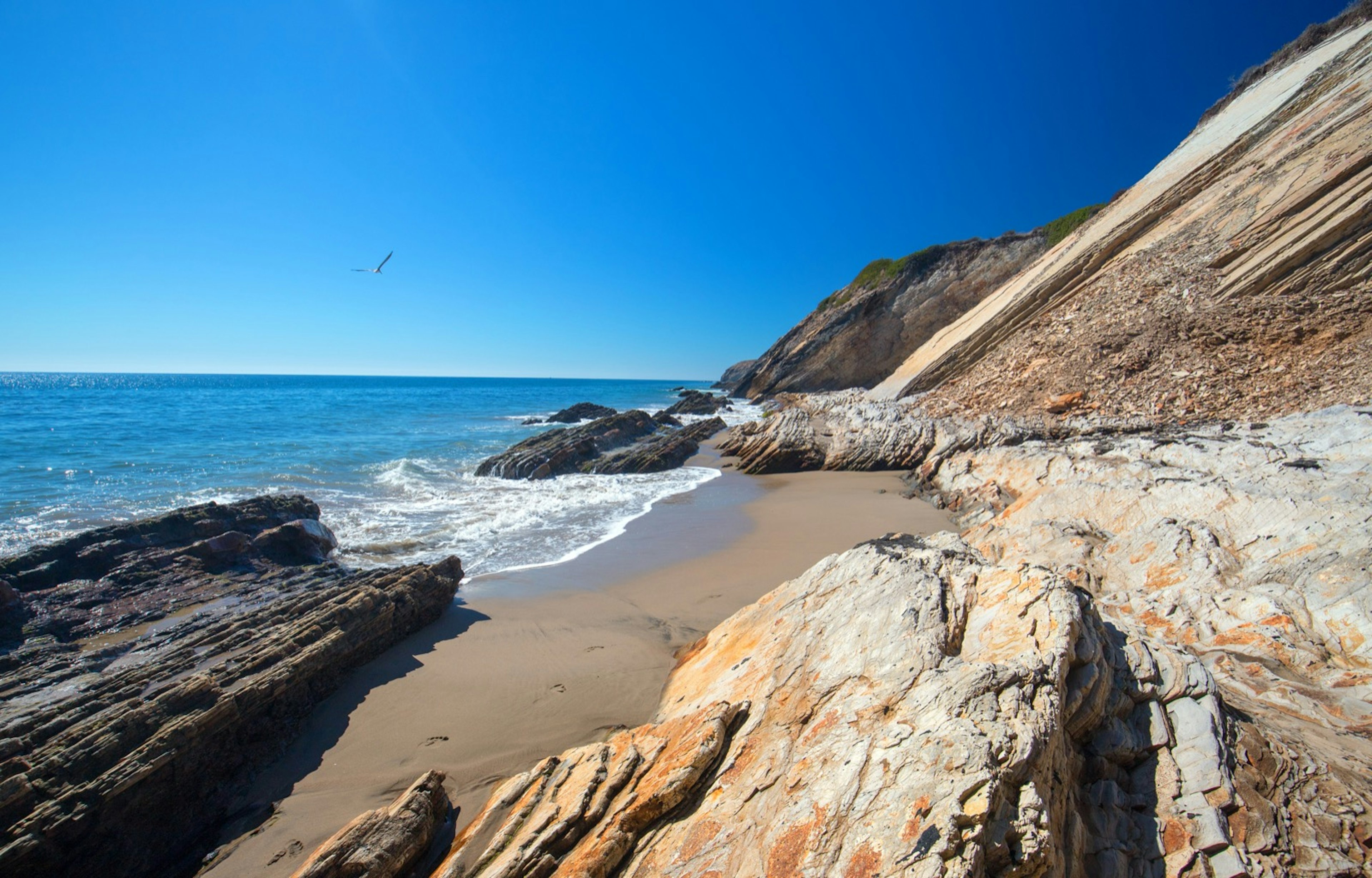 Rocks surround a sandy cove on the beach in Gaviota State Park