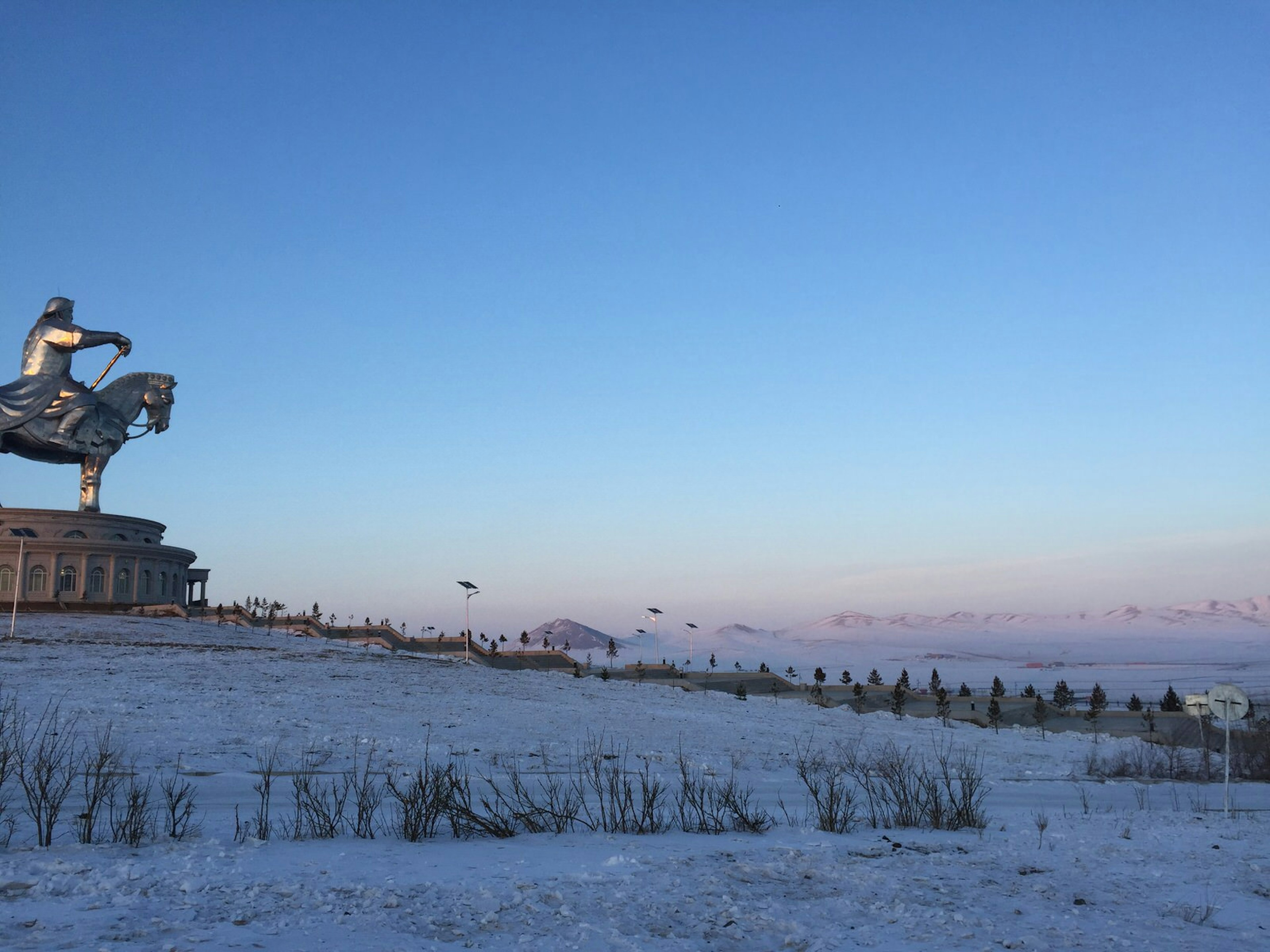 The giant Chinggis Khaan statue, depicting a man on a horse, looks out over the wintry steppe