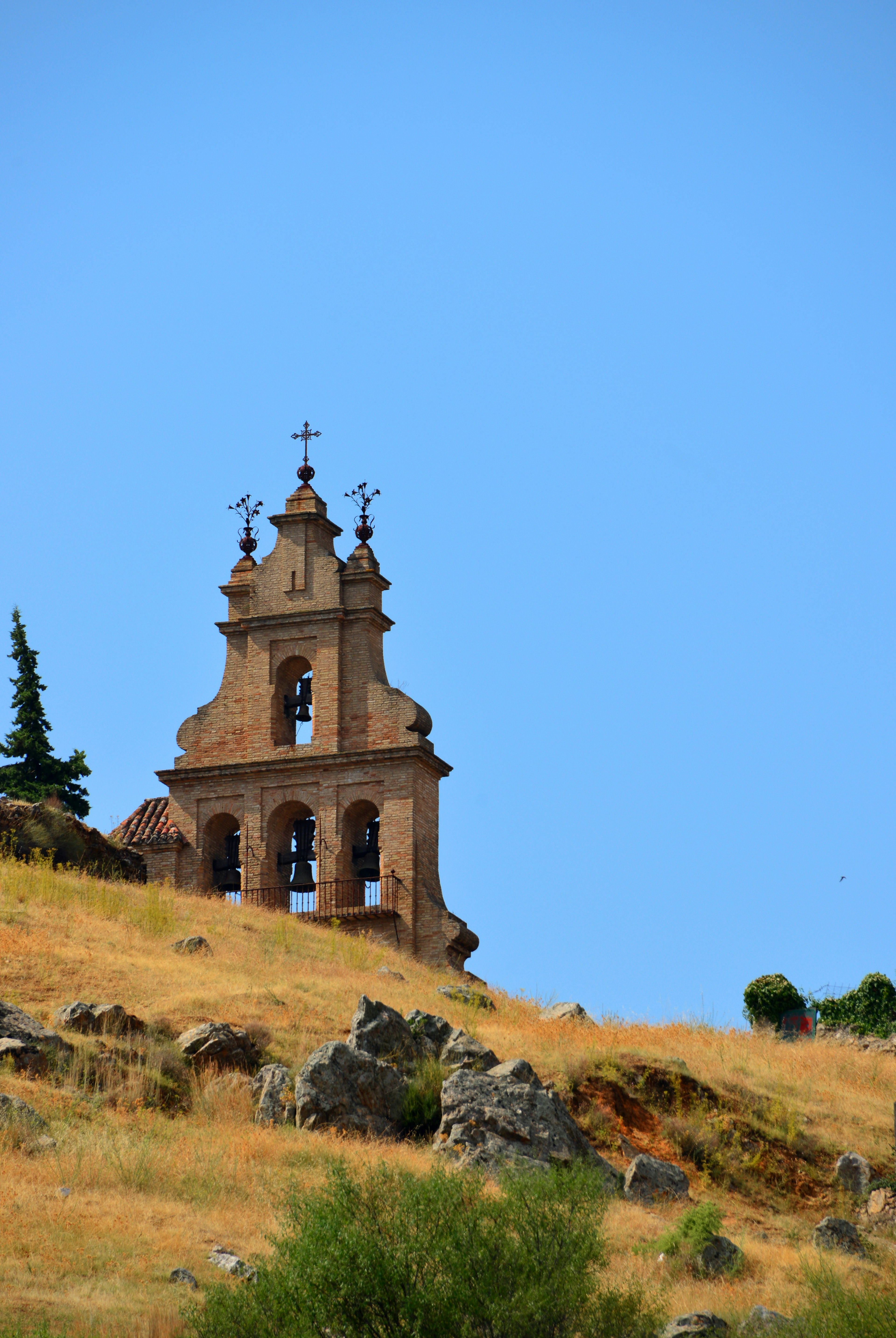 Aracena, Ի岹ܳí, Spain: Bell-gable of the Priory Church seen against the sky - church built by the Knights Templar Order in Moorish-style - Iglesia Prioral de Nuestra Señora del Mayor Dolor o del Castillo, Hermanad de la Vera Cruz, espadaña