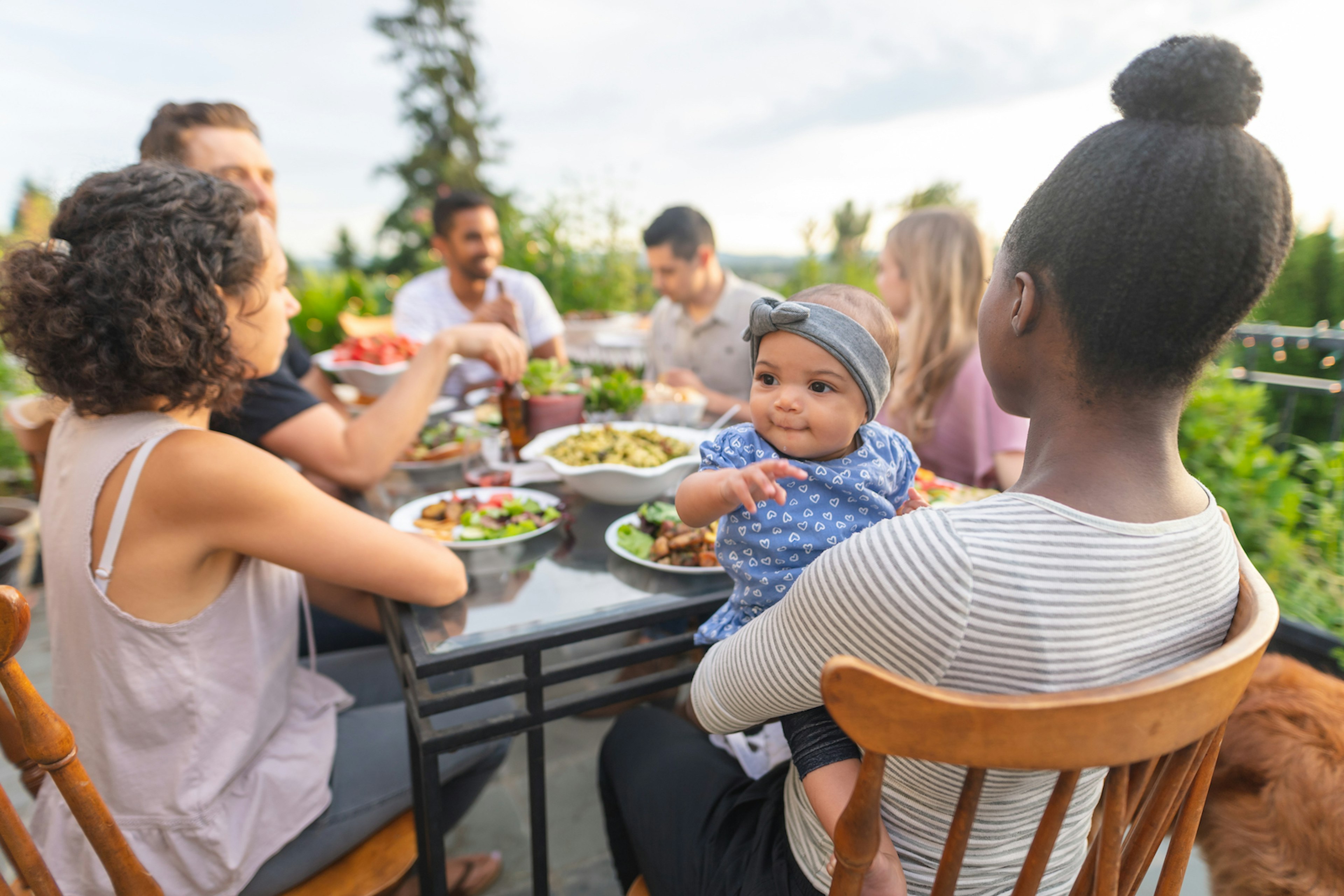 A multi-generational family have an al fresco dinner